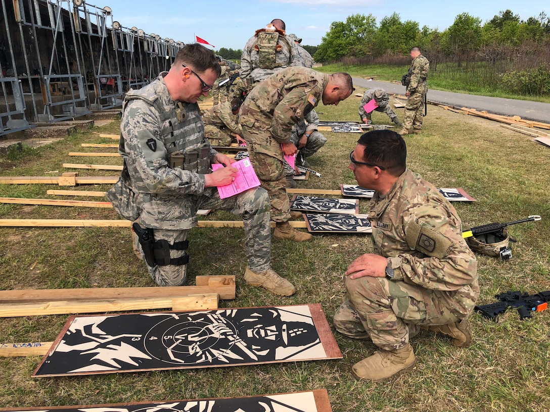 Maj Eric Manewal, 194th Wing, scores targets with Army personnel during the 47th Annual Winston P. Wilson Championship, Robinson Maneuver Training Center, Arkansas, May 1, 2018.  The annual events, hosted by the National Guard Marksmanship Training Center April 29-May 4, 2018, offer Servicemembers from the National Guard and international community an opportunity to test marksmanship skills in a battle-focused environment. (U.S. Air National Guard photo by Staff Sgt. Hope Funderburk)
