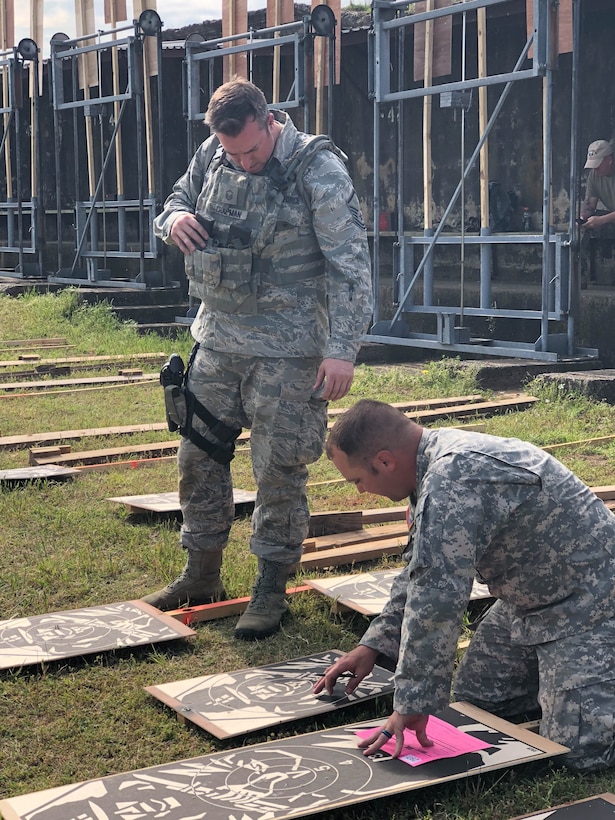 Master Sgt. Michael Chapman, 194th Security Forces Squadron, verifies scores with Army personnel during the 47th Annual Winston P. Wilson Championship, Robinson Maneuver Training Center, Arkansas, May 1, 2018.  The annual events, hosted by the National Guard Marksmanship Training Center April 29-May 4, 2018, offer Servicemembers from the National Guard and international community an opportunity to test marksmanship skills in a battle-focused environment. (U.S. Air National Guard photo by Staff Sgt. Hope Funderburk)