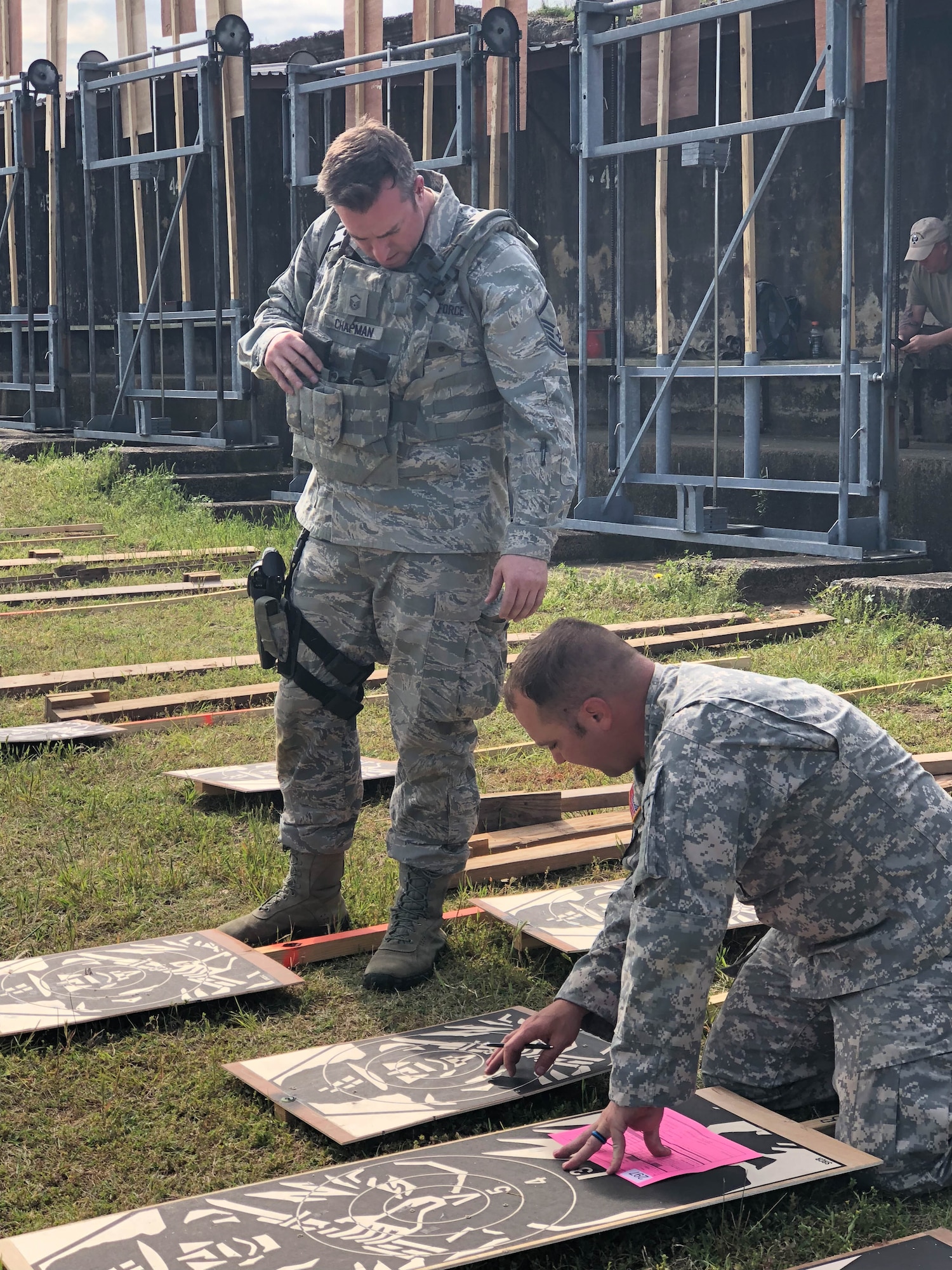Master Sgt. Michael Chapman, 194th Security Forces Squadron, verifies scores with Army personnel during the 47th Annual Winston P. Wilson Championship, Robinson Maneuver Training Center, Arkansas, May 1, 2018.  The annual events, hosted by the National Guard Marksmanship Training Center April 29-May 4, 2018, offer Servicemembers from the National Guard and international community an opportunity to test marksmanship skills in a battle-focused environment. (U.S. Air National Guard photo by Staff Sgt. Hope Funderburk)