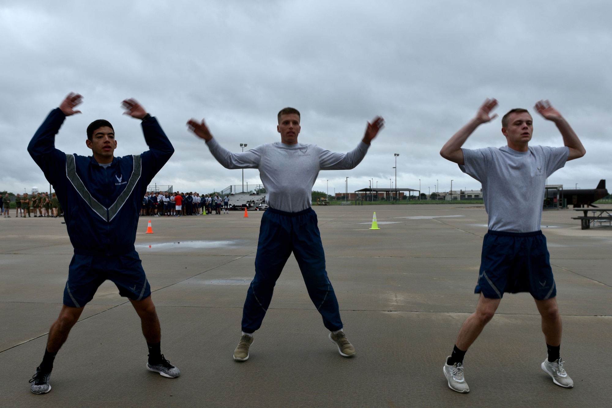 Airman Jake Peterson, Airman 1st Class Garrett Rivett and Airman Haden Stoner, 312th Training Squadron students, perform jumping jacks during the Blood, Sweat and Stairs competition at the Louis F. Garland Department of Defense Fire Academy on Goodfellow Air Force Base, Texas, Sept. 22, 2018. The 312th TRS hosted the event, but many members from the Army, Marines and the Air Force participated. (U.S. Air Force photo by Senior Airman Randall Moose/Released)