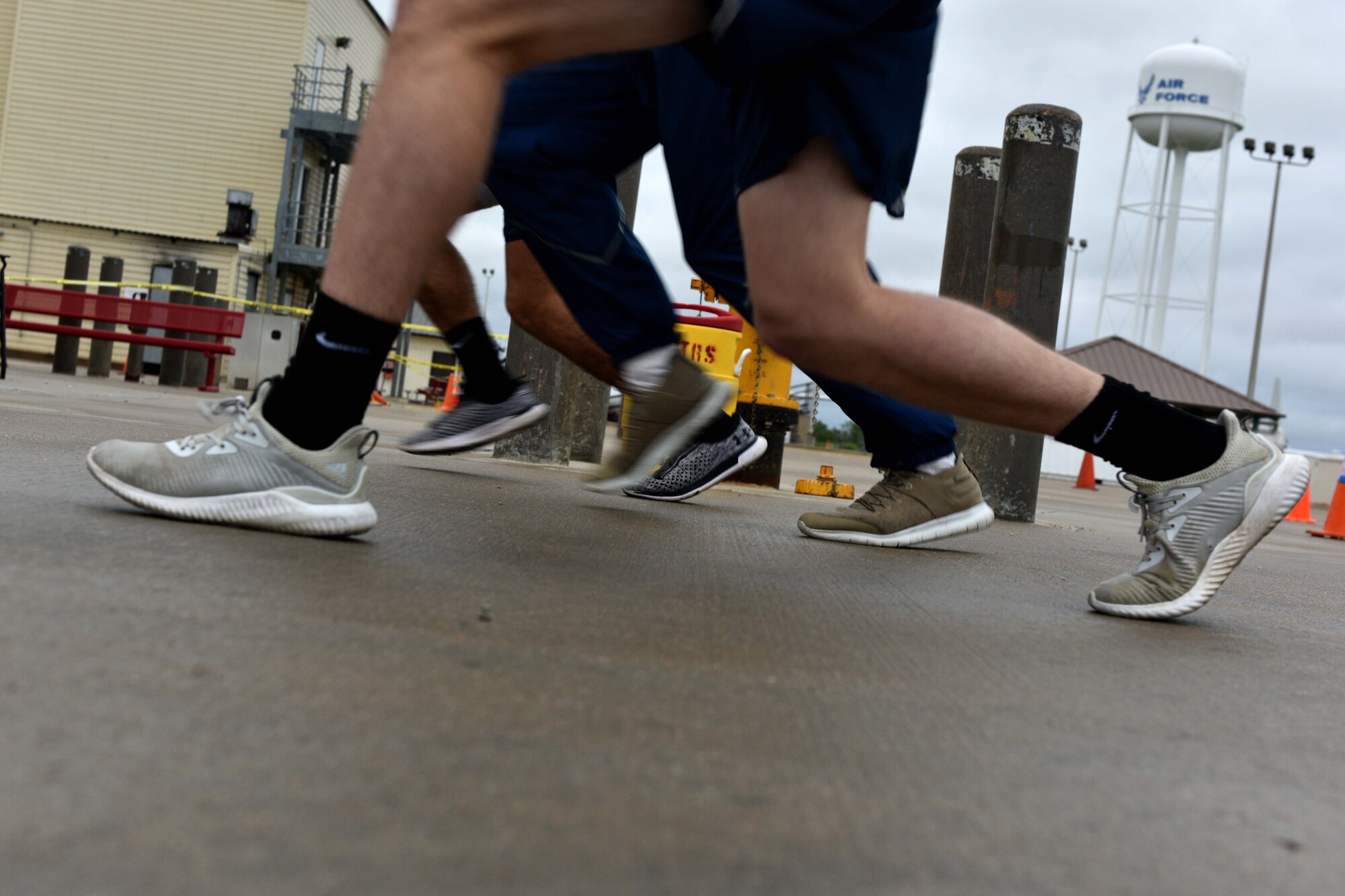 Airman Haden Stoner, Airman 1st Class Garrett Rivett and Airman Jake Peterson, 312th Training Squadron students, perform lunges during the Blood, Sweat and Stairs competition at the Louis F. Garland Department of Defense Fire Academy on Goodfellow Air Force Base, Texas, Sept. 22, 2018. Traditionally, participants would climb stairs to pay tribute to the first responders who died during 9/11. (U.S. Air Force photo by Senior Airman Randall Moose/Released)