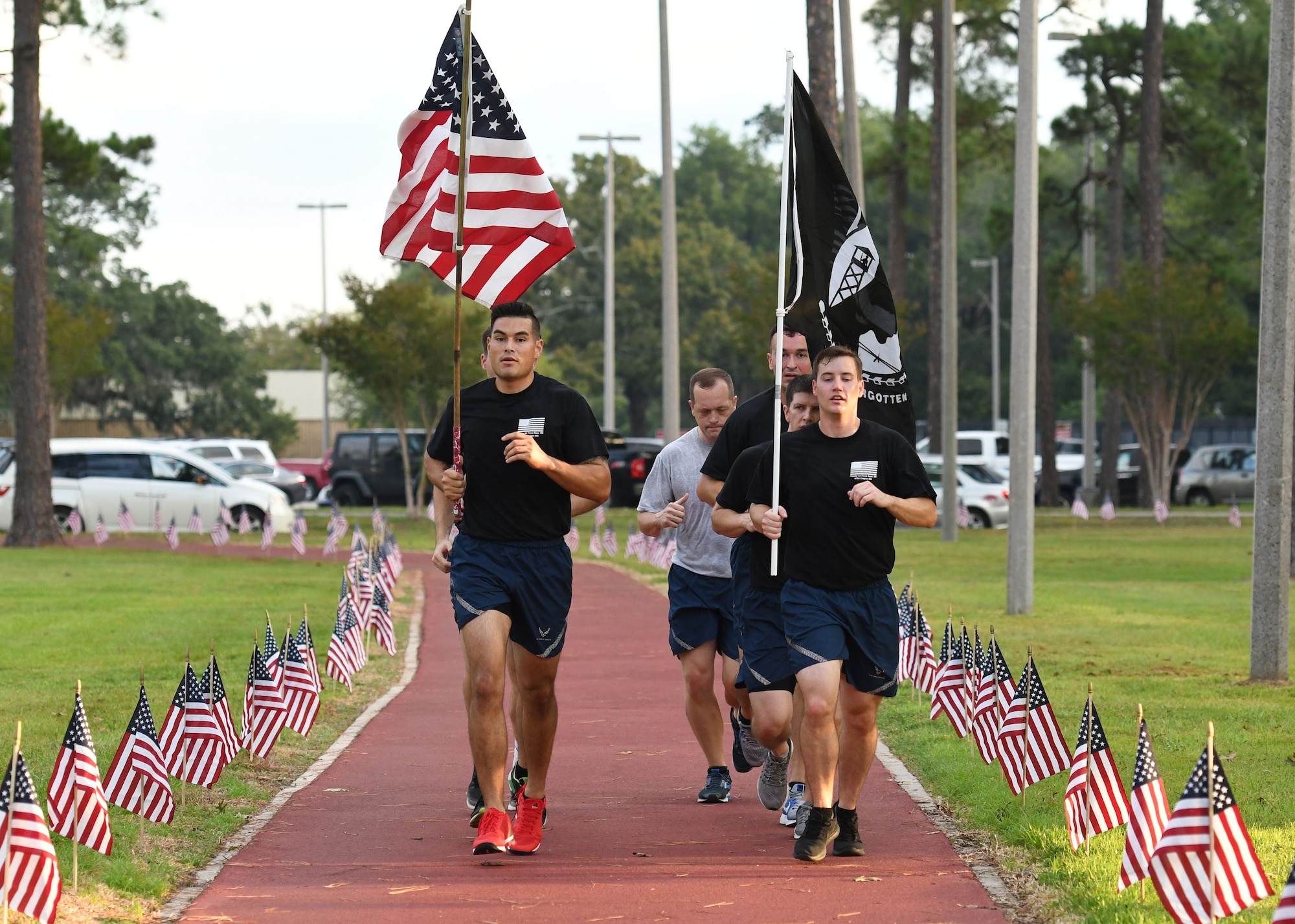 Members of the 81st Training Support Squadron participate in Keesler's POW/MIA 24-hour memorial run and vigil at the Crotwell Track at Keesler Air Force Base, Mississippi, Sept. 20, 2018. The event was held to raise awareness and pay tribute to all prisoners of war and those military members still missing in action. (U.S. Air Force photo by Kemberly Groue)