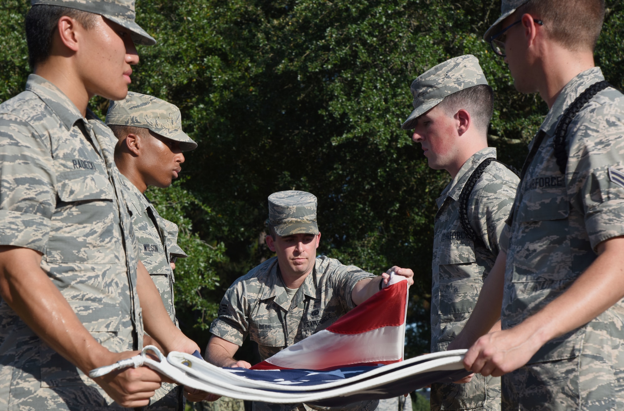 Keesler Airmen participate in folding the U.S. Flag during the POW/MIA Retreat Ceremony at Keesler Air Force Base, Mississippi, Sept. 20, 2018. The event was held to raise awareness and to pay tribute to all prisoners of war and those military members still missing in action. (U.S. Air Force photo by Kemberly Groue)