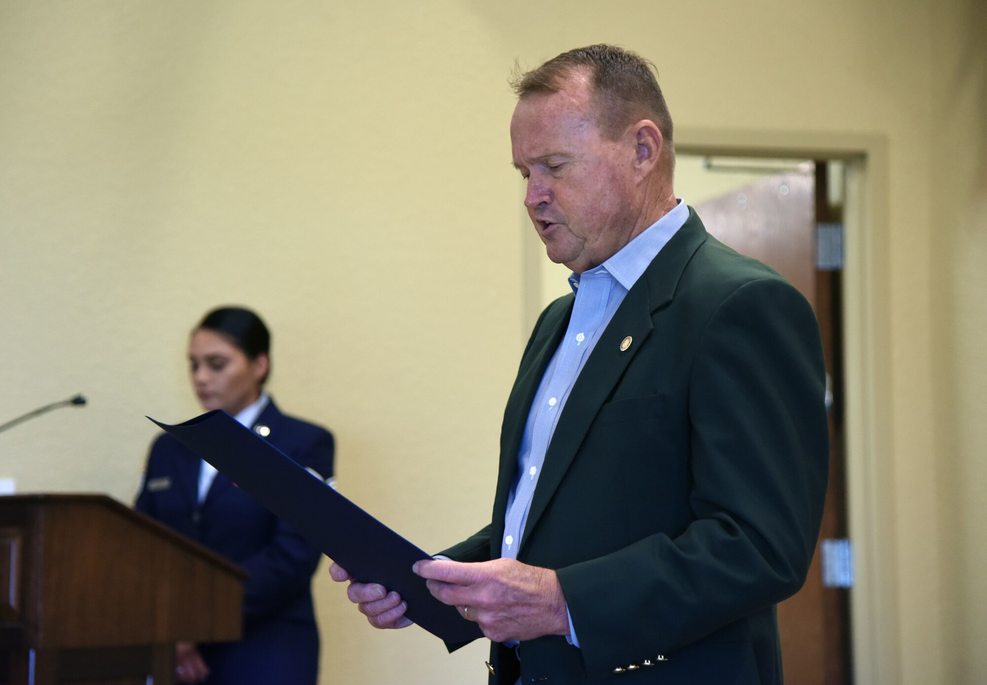Mike Leonard, Biloxi city administrator, reads a "Prisoner Of War and Missing In Action Remembrance Day in the City of Biloxi" proclamation during the POW/MIA Remembrance Luncheon at the Bay Breeze Event Center at Keesler Air Force Base, Mississippi, Sept. 21, 2018.The event, hosted by the Air Force Sergeants Association, was held to raise awareness and to pay tribute to all prisoners of war and those military members still missing in action. (U.S. Air Force photo by Kemberly Groue)