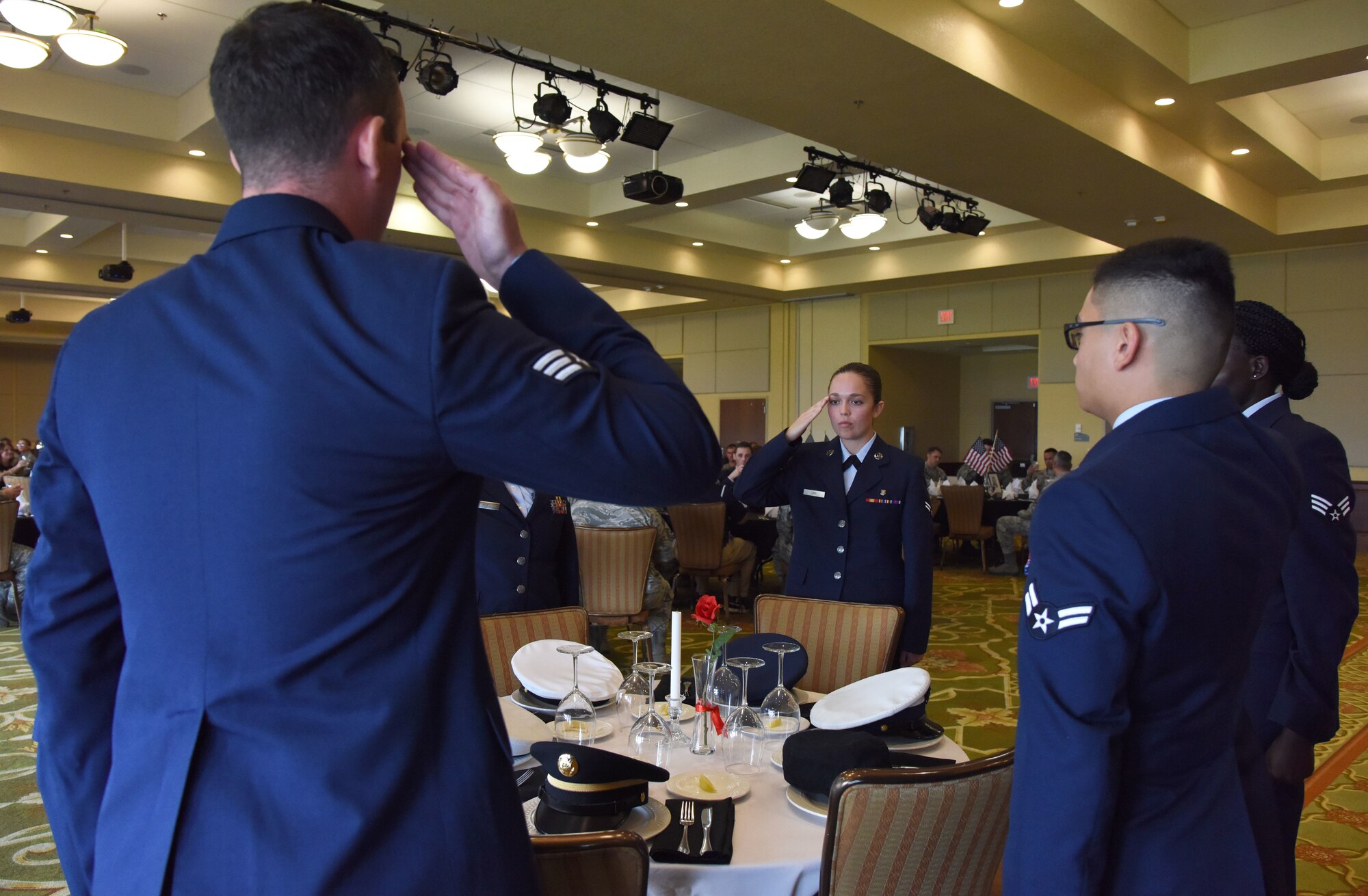 Keesler Airmen participate in a POW/MIA table ceremony during the POW/MIA Remembrance Luncheon at the Bay Breeze Event Center at Keesler Air Force Base, Mississippi, Sept. 21, 2018. The event, hosted by the Air Force Sergeants Association, was held to raise awareness and to pay tribute to all prisoners of war and those military members still missing in action. (U.S. Air Force photo by Kemberly Groue)