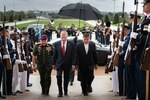 Defense Secretary James N. Mattis walks up steps with Malaysian Defense Minister Mohamad Sabu.