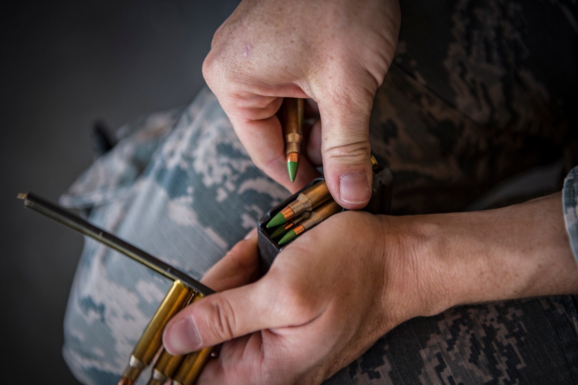 Staff Sgt. Katie McDermott, 99th Security Forces Squadron military working dog handler, loads ammunition into a magazine at Nellis Air Force Base, Nevada, Sept. 19, 2018. The training required the military working dog handlers to fire an M4 carbine and M9 pistol while moving through the course with their military working dog. (U.S. Air Force photo by Airman 1st Class Andrew D. Sarver)