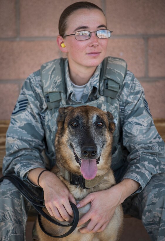 Staff Sgt. Katie McDermott, 99th Security Forces Squadron military working dog handler, sits with Pprada, her military working dog, at Nellis Air Force Base, Nevada, Sept. 19, 2018. McDermott and Pprada have been partners since November 2017. (U.S. Air Force photo by Airman 1st Class Andrew D. Sarver)
