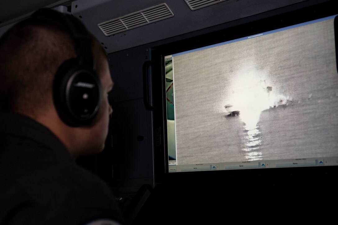 U.S. Navy Aircrewman Operator 3rd Class Jonathan Ziminski with Patrol Squadron (VP) 45 views a sink exercise, part of Exercise Valiant Shield 18 at Andersen Air Force Base, Guam, Sept. 23, 2018. Valiant Shield is a biennial, U.S. only, field training exercise (FTX) with a focus on integration of joint training among U.S. forces in relation to current operational plans. This training enables real-world proficiency in sustaining joint forces through detecting, locating, tracking and engaging units at sea, in the air, on land, and in cyberspace in response to a range of mission areas. (U.S. Marine Corps photo by Lance Cpl. Seth Rosenberg)
