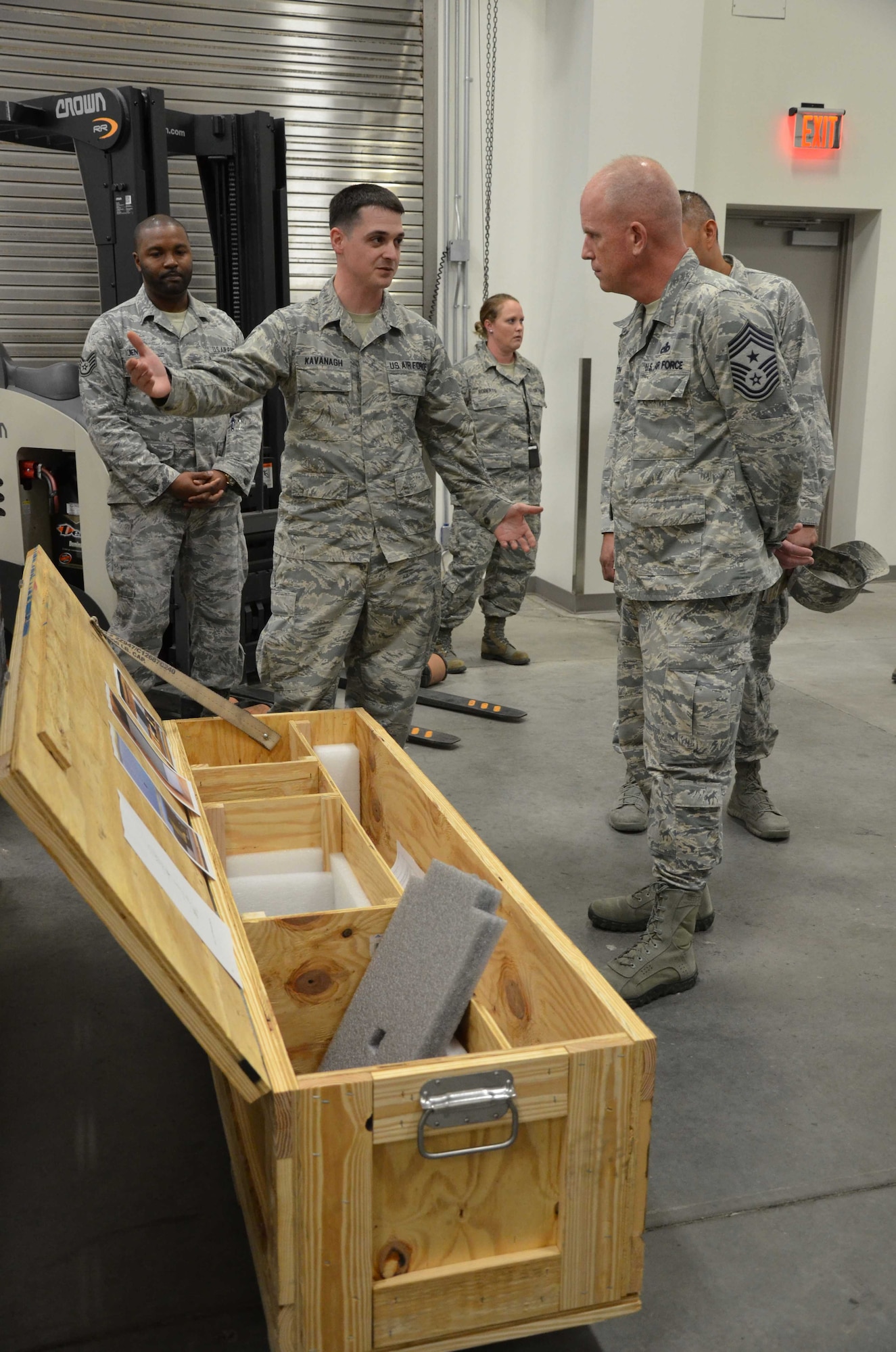 Tech. Sgt. Timothy Kavanagh, noncommissioned officer-in-charge of product support for the Air Force Technical Applications Center, Patrick AFB, Fla., explains to Chief Master Sgt. Frank Batten, command chief of Air Combat Command, how he designed a crate to better ship, house and store AFTAC's precision seismic equipment that is used to monitor worldwide nuclear activity.  (U.S. Air Force photo by Susan A. Romano)