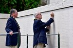 U.S. Army Col. (Ret.) Charles H. McDaniel, Jr., watches his brother, Larry McDaniel, place a rosette next to their father's name, U.S. Army Master Sgt. Charles H. McDaniel, Sr., at the National Memorial Cemetery of the Pacific, Honolulu, Hawaii, Sept. 21, 2018. McDaniel, Sr., was recently identified by the Defense POW/MIA Accounting Agency after his remains were returned during a unilateral transfer from the Democratic People’s Republic of Korea. (U.S. Army photo by Staff Sgt. Michael O'Neal)