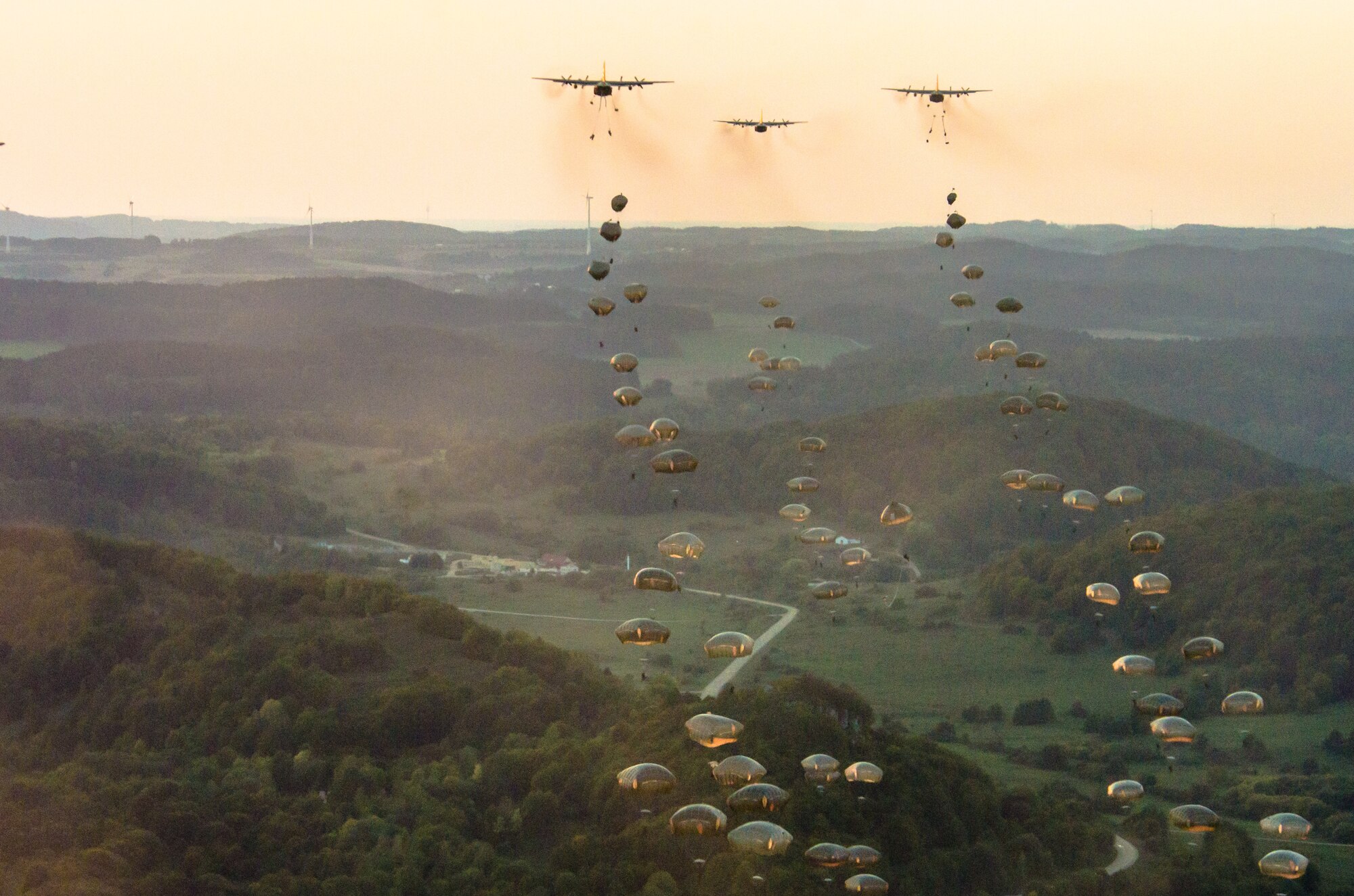 U.S. Army soldiers from the 173rd Airborne Brigade, as well as soldiers from various allied nations, parachute from U.S. Air Force C-130 aircraft onto a drop zone in Germany, Sept. 19, 2018. Saber Junction 18 is the U.S. Army 173rd Airborne Brigade’s combat training center certification exercise, taking place on the Grafenwoehr and Hohenfels training areas. The U.S. Army Europe-directed exercise is designed to assess the readiness of the brigade to conduct unified land operations in a joint, combined environment and to promote interoperability with participating allies and partner nations. Saber Junction 18 includes nearly 5,500 participants from 20 ally and partner nations. (U.S. Air National Guard photo by Staff Sgt. Patrick Evenson)