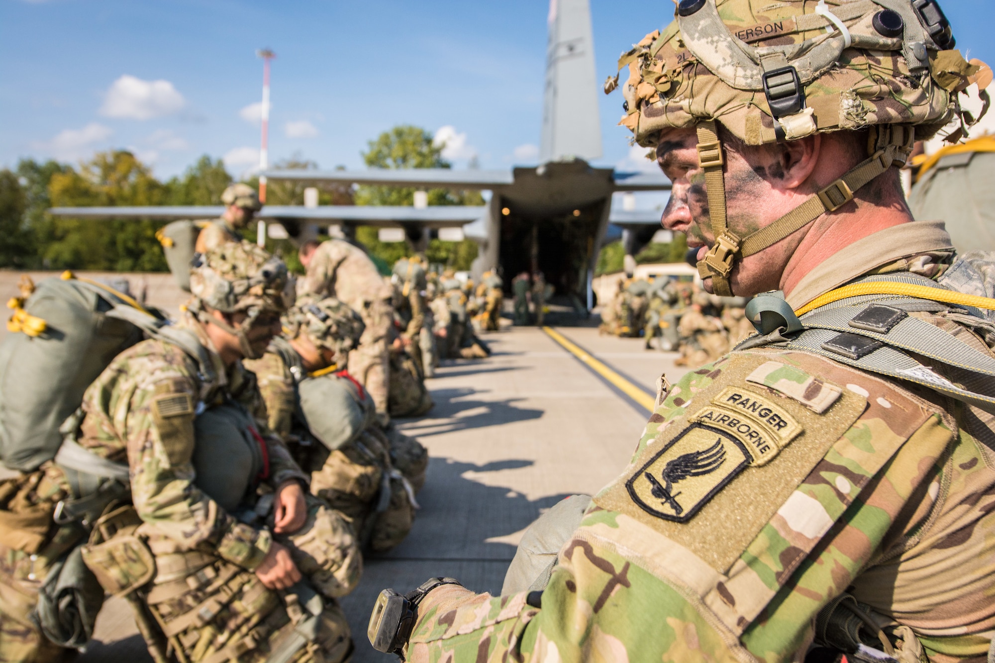U.S. Army paratroopers with the 173rd Airborne Brigade sit and wait to board a U.S. Air Force C-130 aircraft assigned to the 139th Airlift Wing, Missouri Air National Guard, during Saber Junction 18, at Ramstein Air Base, Germany, Sept. 19, 2018. Saber Junction 18 is the U.S. Army 173rd Airborne Brigade’s combat training center certification exercise, taking place on the Grafenwoehr and Hohenfels training areas. The U.S. Army Europe-directed exercise is designed to assess the readiness of the brigade to conduct unified land operations in a joint, combined environment and to promote interoperability with participating allies and partner nations. Saber Junction 18 includes nearly 5,500 participants from 20 ally and partner nations. (U.S. Air National Guard photo by Staff Sgt. Patrick Evenson)