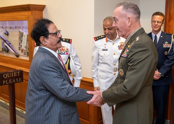Chairman of the Joint Chiefs of Staff Gen. Joseph F. Dunford, Jr. greets Bahraini Minister for Defense Affairs Lt. Gen. Yusuf bin Ahmad bin Husayn al-Jalahma at the Pentagon in Washington D.C., Sept. 24, 2018