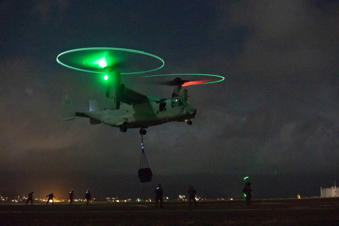 U.S. Marines with Combat Logistics Battalion 3 and Marine Medium Tiltrotor Squadron 363 team up during a helicopter support team exercise at Landing Zone Westfield, Marine Corps Base Hawaii, Sept. 20, 2018. The HST exercise provides training to landing support specialists with CLB-3 and VMM-363 pilots more proficient in the insertion and extraction of objects in restrictive terrain.