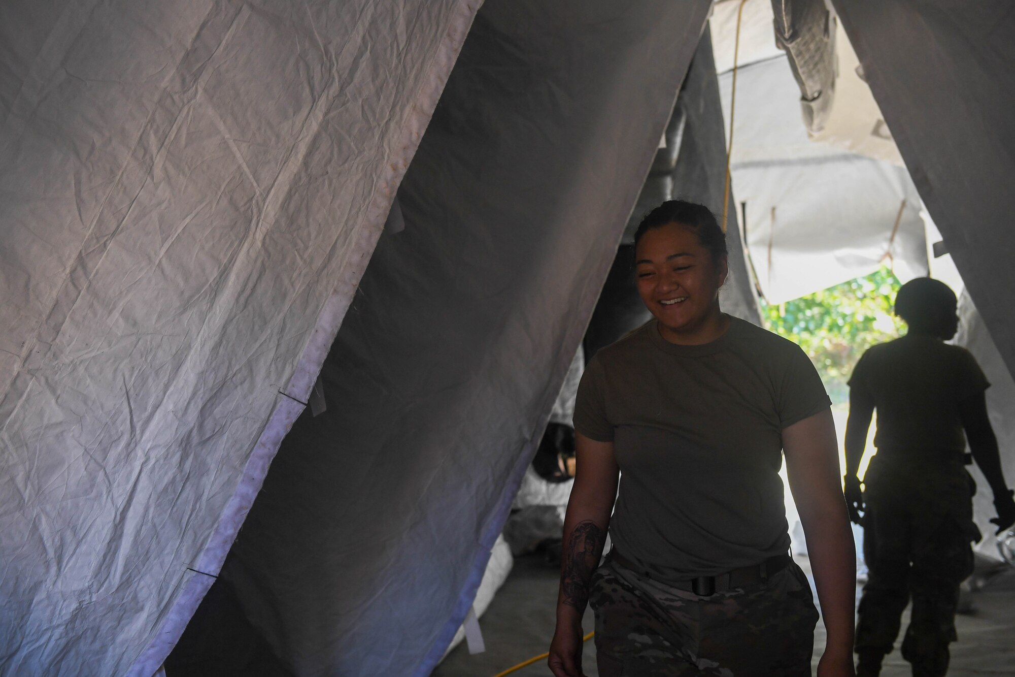 U.S. Army Darlene Graham, 689th Rapid Port Opening Element, 832nd Transportation Battalion, 597th Transportation Brigade transportation clerk, takes down a deployable airbase system tent during Exercise Turbo Distribution 18-02 at Fort McCoy, Wisconsin, Sept. 9, 2018. The DABS are used to construct the foundations for an airbase in a deployed location when service members are rapidly moved into an area.  (U.S. Air Force photo by Senior Airman Derek Seifert)