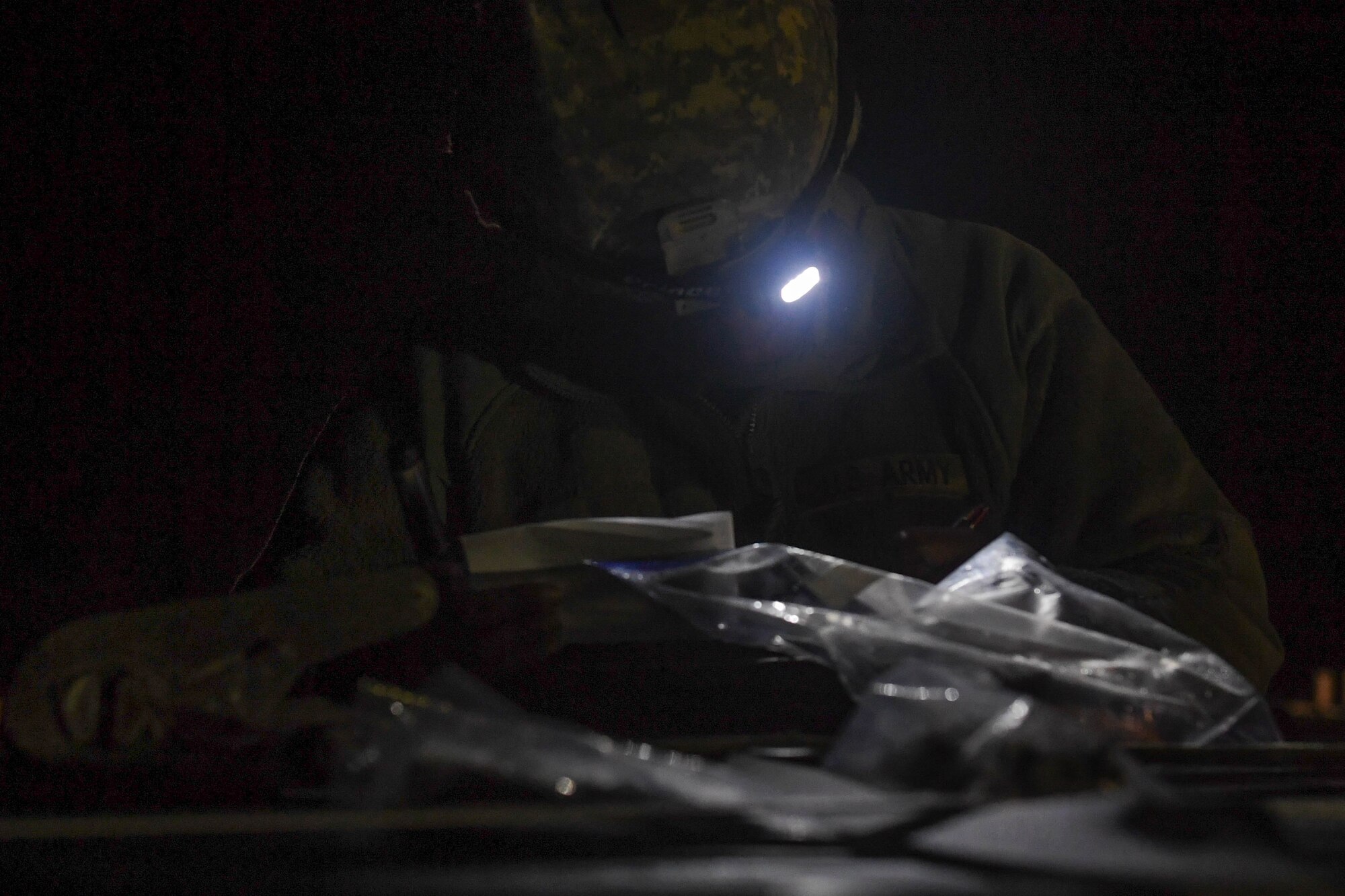 U.S. Army Spc. Quamiya Sweeting, 689th Rapid Port Opening Element, 832nd Transportation Battalion, 597th Transportation Brigade transportation management coordinator, checks tag labels to track cargo during Exercise Turbo Distribution 18-02 at Fort McCoy, Wisconsin, Sept. 9, 2018. Sweeting and Soldiers at the forward cargo yard tracked cargo ensuring the correct number and type of products were received, then processed the correct cargo out of the yard to their customers. (U.S. Air Force photo by Senior Airman Derek Seifert)