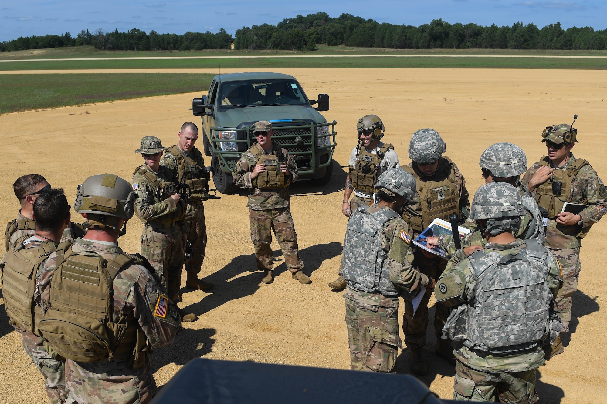 The Joint Assessment Team discusses a potential secondary airfield during Exercise Turbo Distribution 18-02 at Fort McCoy, Wisconsin, Sept. 9, 2018. The JAT assesses and surveys potential airfields that provides enough room for aircraft to safely land and unload cargo, as well locations for cargo yards, and security vulnerabilities that would require attention. (U.S. Air Force photo by Senior Airman Derek Seifert)