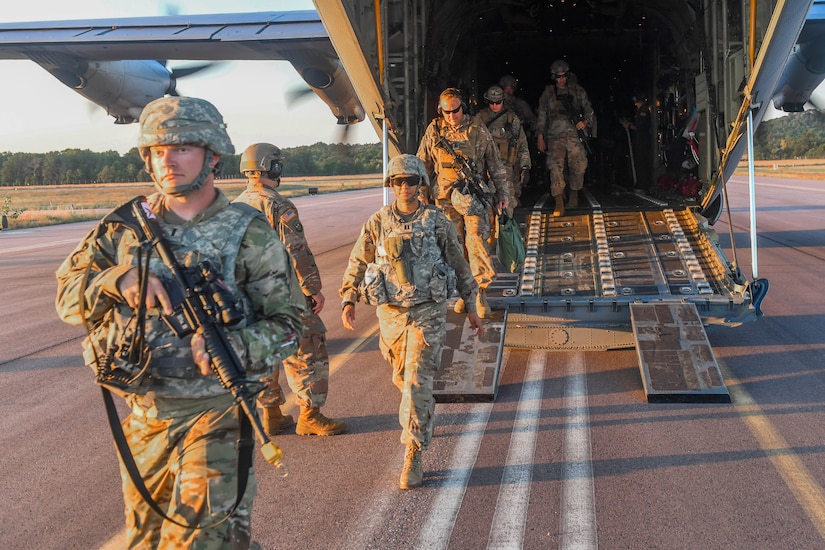 U.S. Army Soldiers and U.S. Air Force Airmen exit a C-130J Super Hercules after assessing a secondary airfield during Exercise Turbo Distribution 18-02 at Fort McCoy, Wisconsin, Sept. 9, 2018. The Joint Assessment Team arrives before the main component to survey potential airfields and cargo yard locations. (U.S. Air Force photo by Senior Airman Derek Seifert)