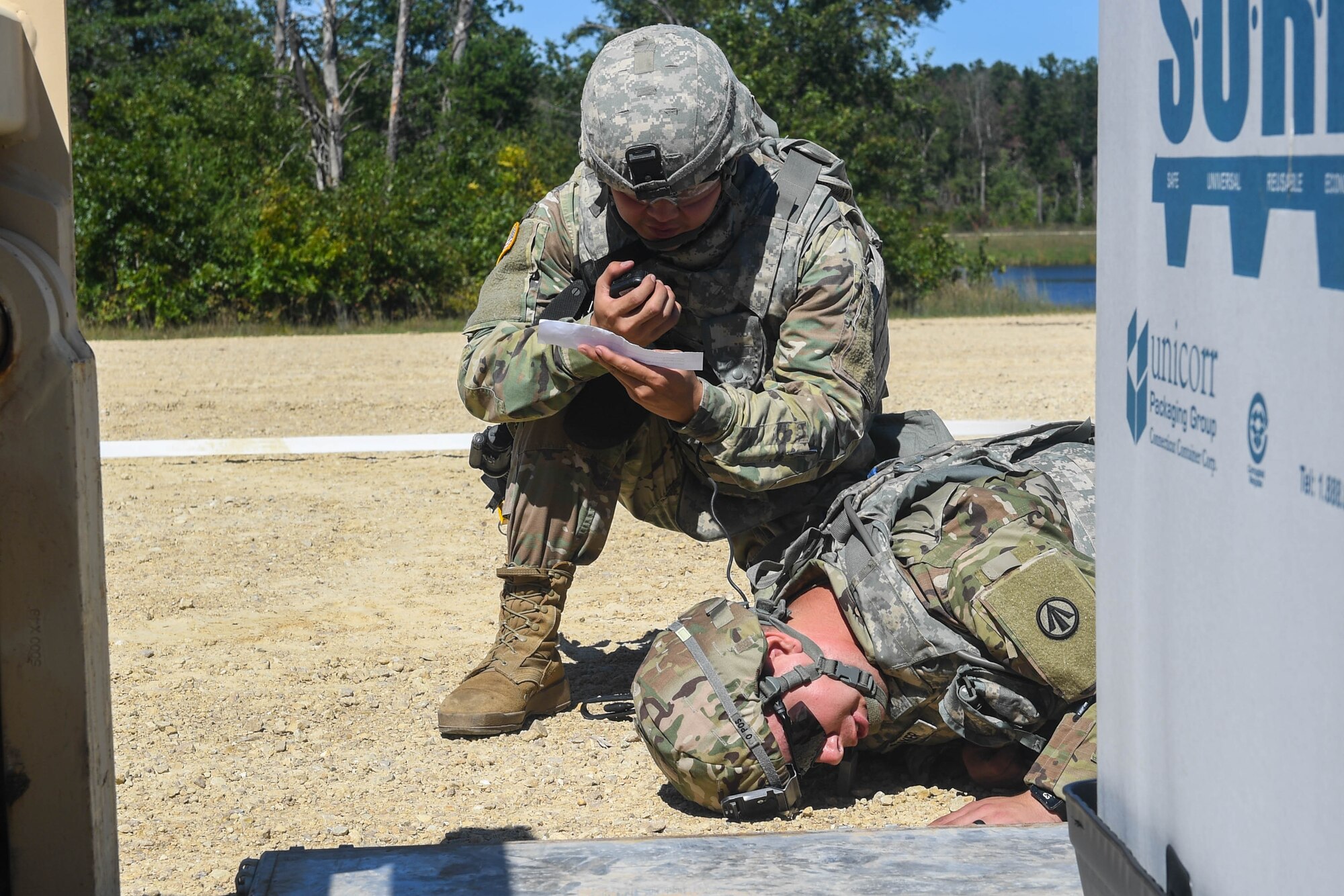 U.S. Army Spc. Hyeongmin Lee, 689th Rapid Port Opening Element, 832nd Transportation Battalion, 597th Transportation Brigade cargo specialist, reports a new simulated scenario over his radio during Exercise Turbo Distribution 18-02 at Fort McCoy, Wisconsin, Sept. 9, 2018. During the exercise, the graders randomly created mishaps or attacks to test the Soldiers and U.S. Air Force Airmen’s capabilities to overcome challenges. (U.S. Air Force photo by Senior Airman Derek Seifert)