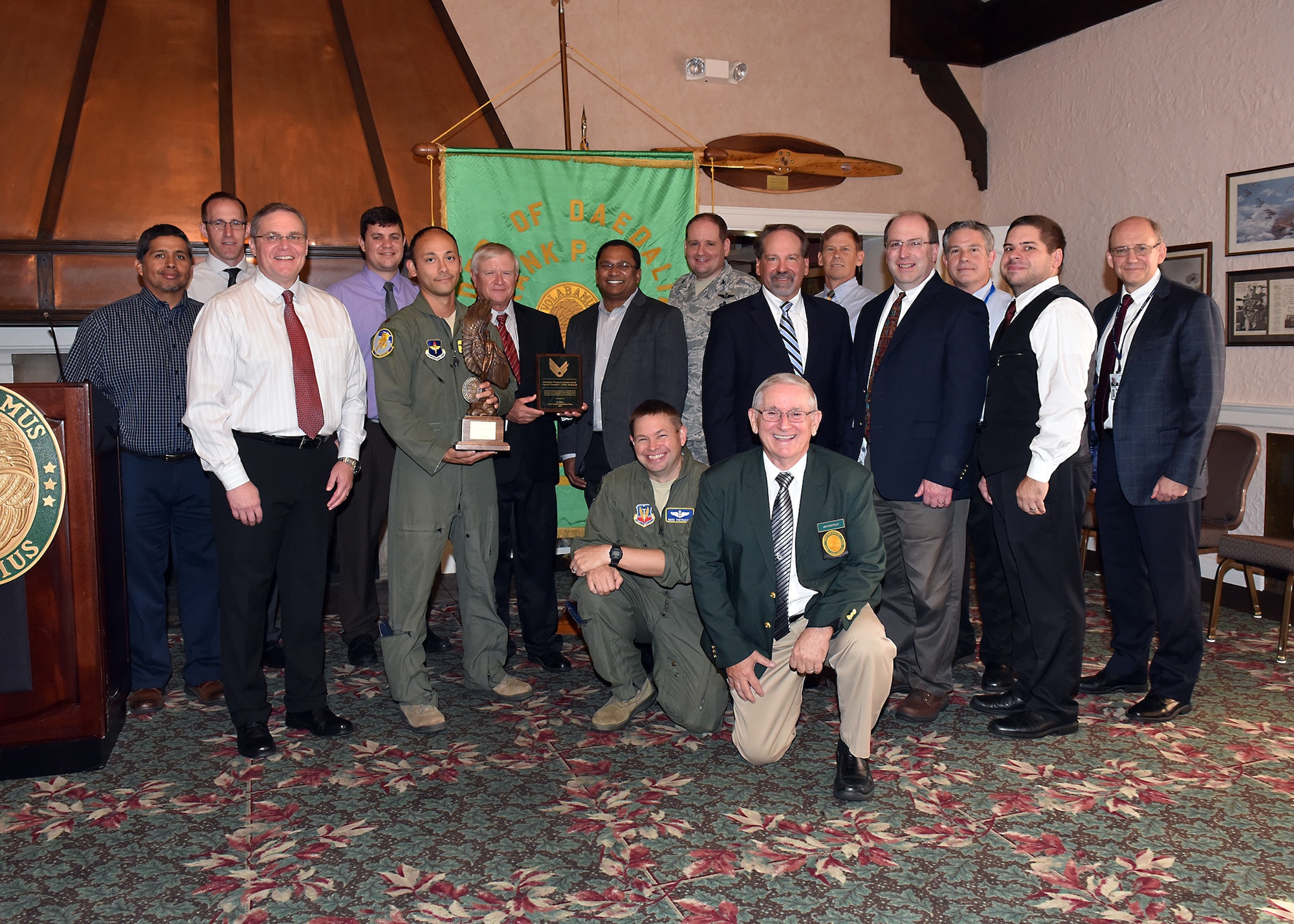 A multi-functional team of experts from across the Air Force Life Cycle Management Center, the Air Force Research Laboratory, several major commands and headquarters Air Force, received the 2017 Daedalian Colonel Franklin C. Wolfe Weapon Systems Award at a Sept. 20, 2018 ceremony at the Wright-Patterson Air Force Base Club. The Air Force Light Attack Experiment Team was presented the award by Jim DeStout, front, Adjutant, Flight 9 – Frank P. Lahm Order of Daedailians, in recognition of completing Phase I of a series of trials to determine the feasibility of using low-cost light attack aircraft in support of air-ground missions. (U.S. Air Force photo/Al Bright)