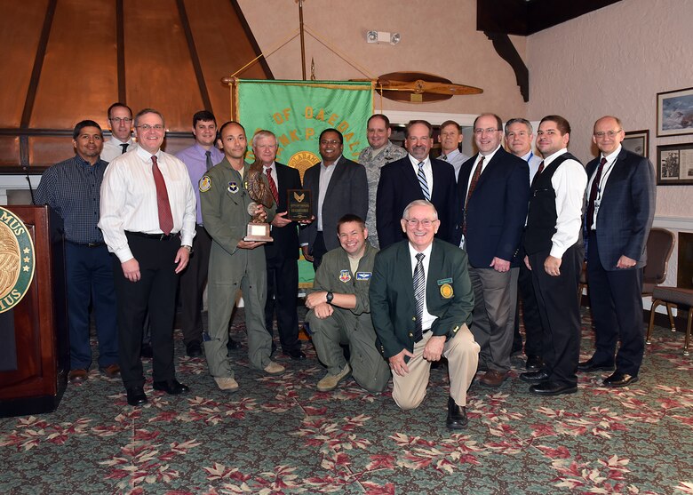 A multi-functional team of experts from across the Air Force Life Cycle Management Center, the Air Force Research Laboratory, several major commands and headquarters Air Force, received the 2017 Daedalian Colonel Franklin C. Wolfe Weapon Systems Award at a Sept. 20, 2018 ceremony at the Wright-Patterson Air Force Base Club. The Air Force Light Attack Experiment Team was presented the award by Jim DeStout, front, Adjutant, Flight 9 – Frank P. Lahm Order of Daedailians, in recognition of completing Phase I of a series of trials to determine the feasibility of using low-cost light attack aircraft in support of air-ground missions. (U.S. Air Force photo/Al Bright)
