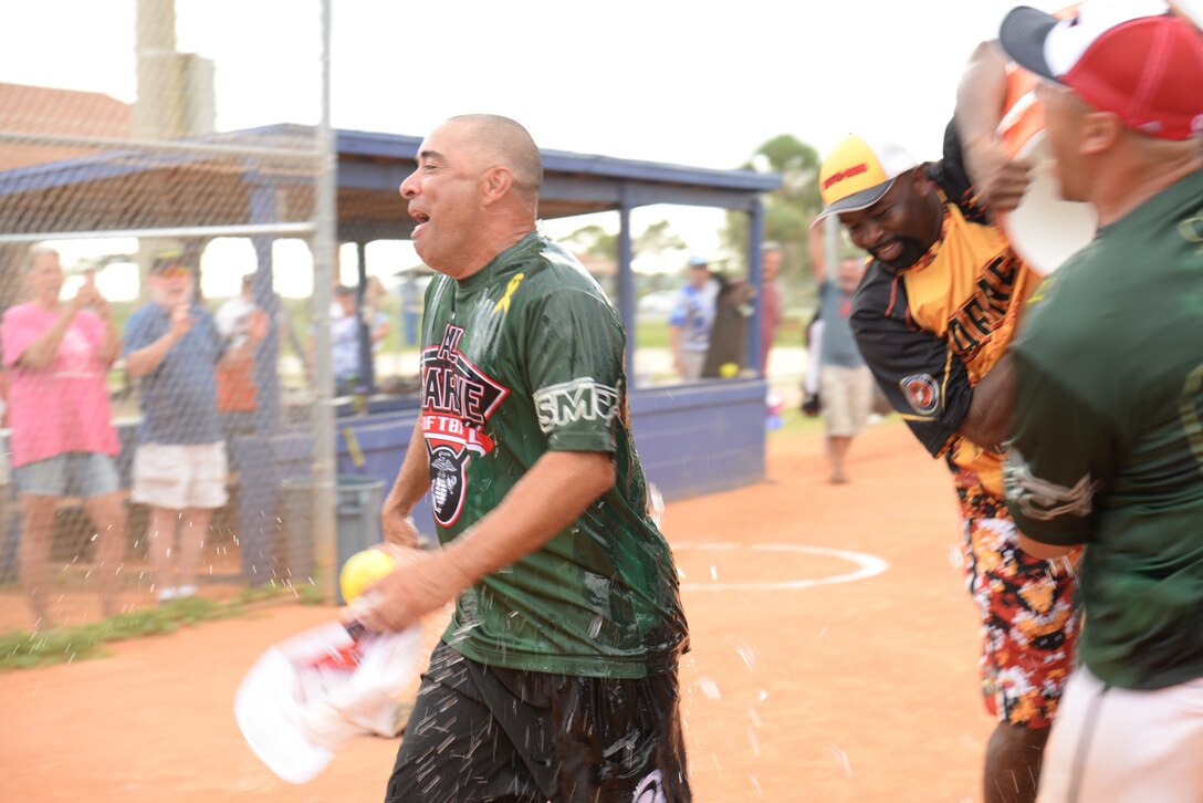 Marines celebrate their first gold medal victory since 2000 with the water bucket over Head Coach Coach Sgt. Maj. Christopher Balcazar