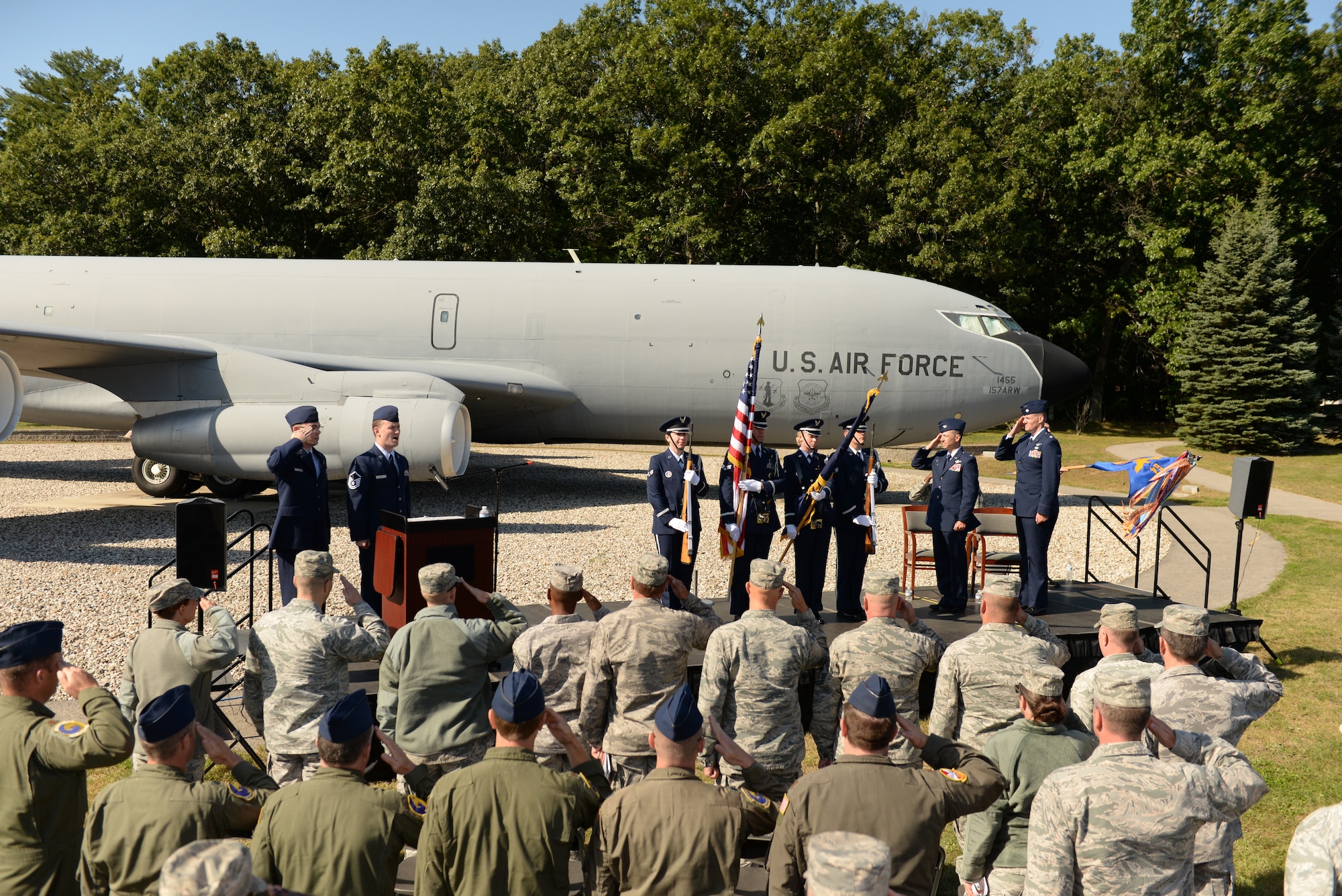 Col. Robert Hanovich Jr, commander of the 22nd Operations Group at McConnell Air Force Base, and Lt. Col. Kevin Eley render a salute as the National Anthem is sang by Master Sgt. William Cole, analyst, 157th Operations Group, during an assumption of command ceremony for Eley, who assumed command of the 64th ARS during a ceremony, Sept. 24, at Pease Air National Guard Base. (Photo by Master Sgt. Thomas Johnson, 157th ARW Public Affairs)
