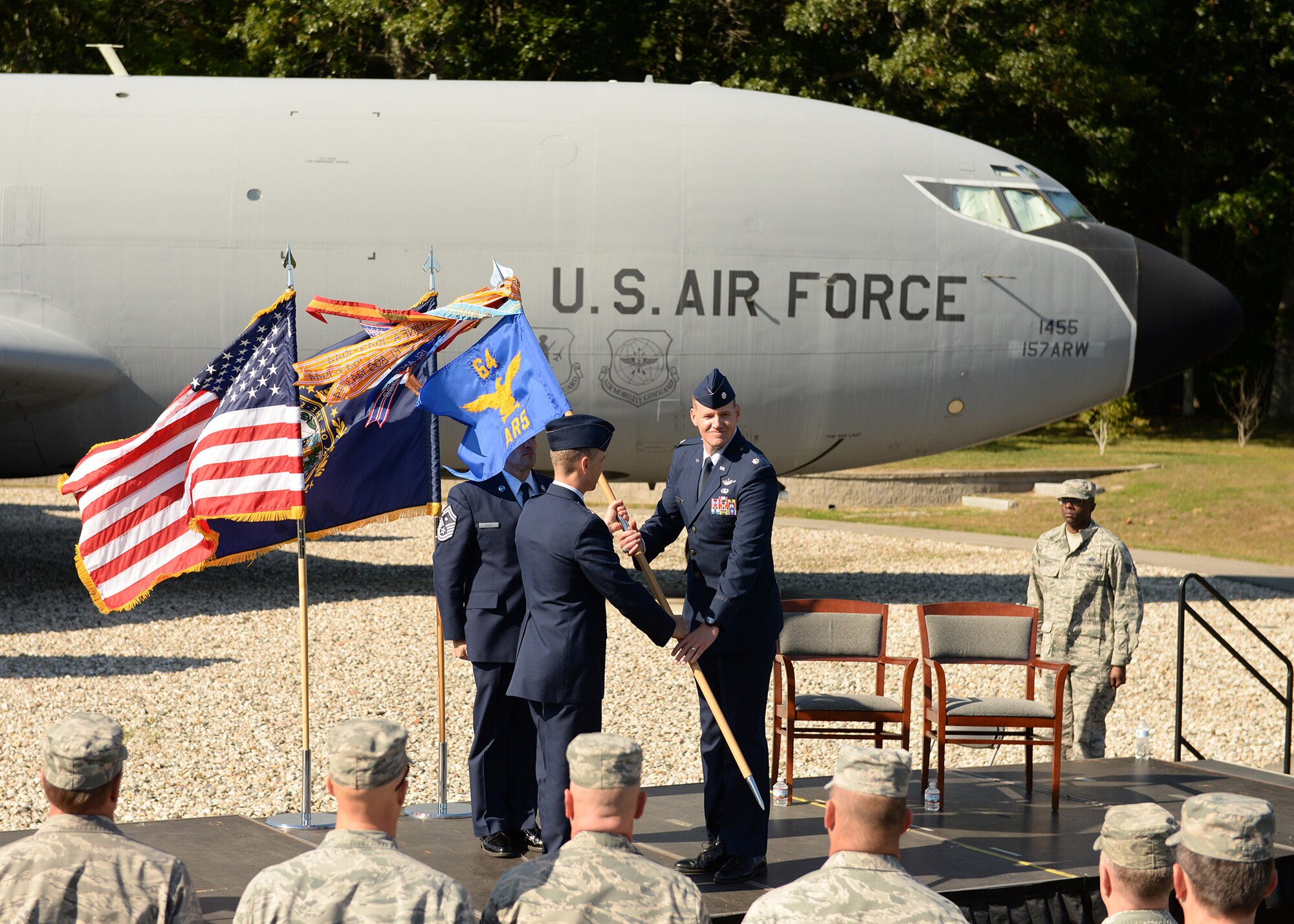 Col. Robert Hanovich Jr, commander of the 22nd Operations Group at McConnell Air Force Base, passes the 64th Air Refueling Squadron guidon to Lt. Col. Kevin Eley, who assumed command of the 64th ARS during a ceremony, Sept. 24, at Pease Air National Guard Base. (Photo by Master Sgt. Thomas Johnson, 157th ARW Public Affairs)