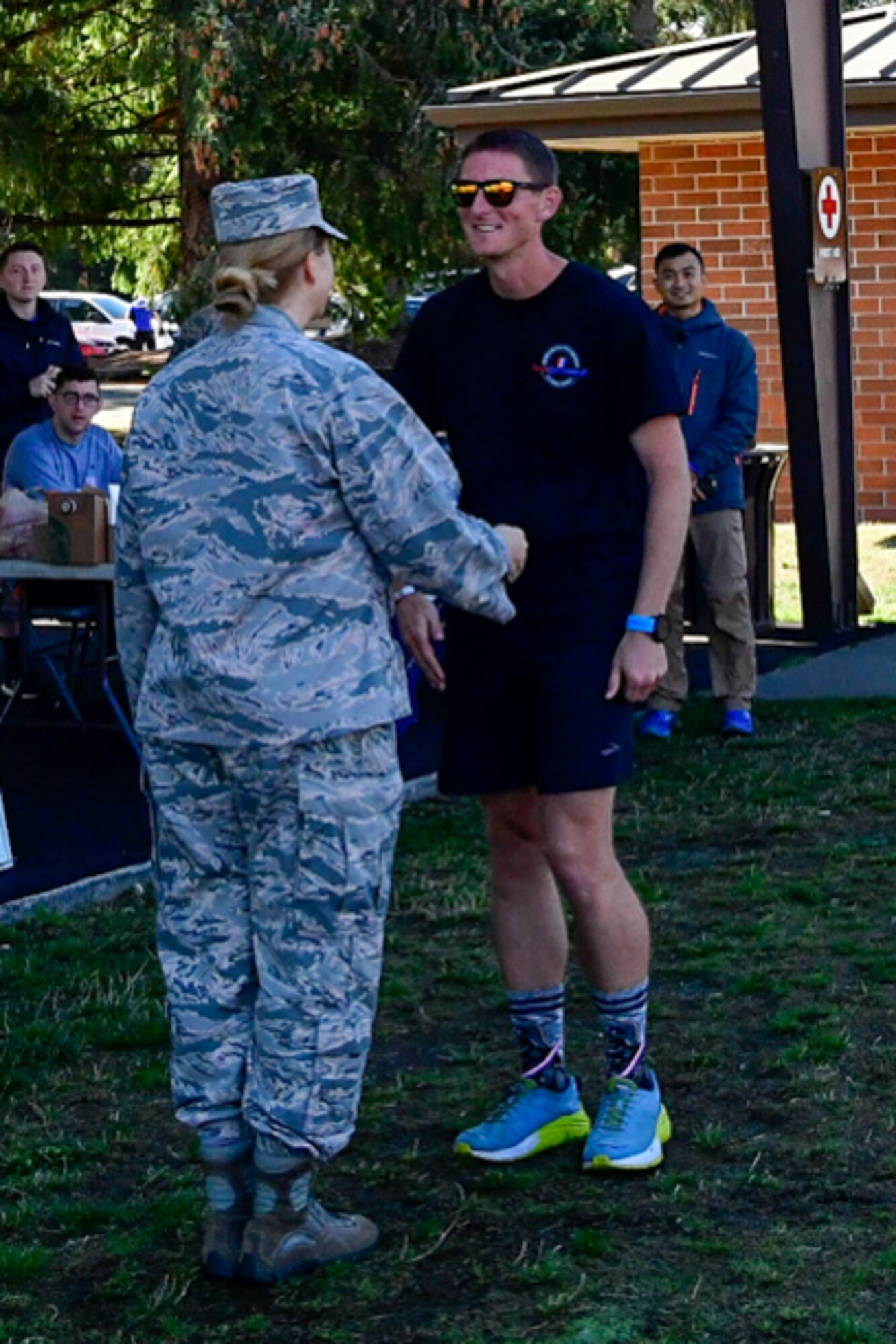 1st Lt. Krosby Keller, right, 225th Air Defense Squadron air battle manager, receives a commander's coin from Col. Erin Staine-Pyne, 62nd Airlift Wing vice commander, for placing first in the individual standings during the Joint Base Lewis-McChord 24-Hour POW/MIA Remembrance Run Sept. 19, 2018.  Keller logged in 100 miles in under 24 hours. (U.S. Air National Guard photo by Maj. Kimberly Burke)
