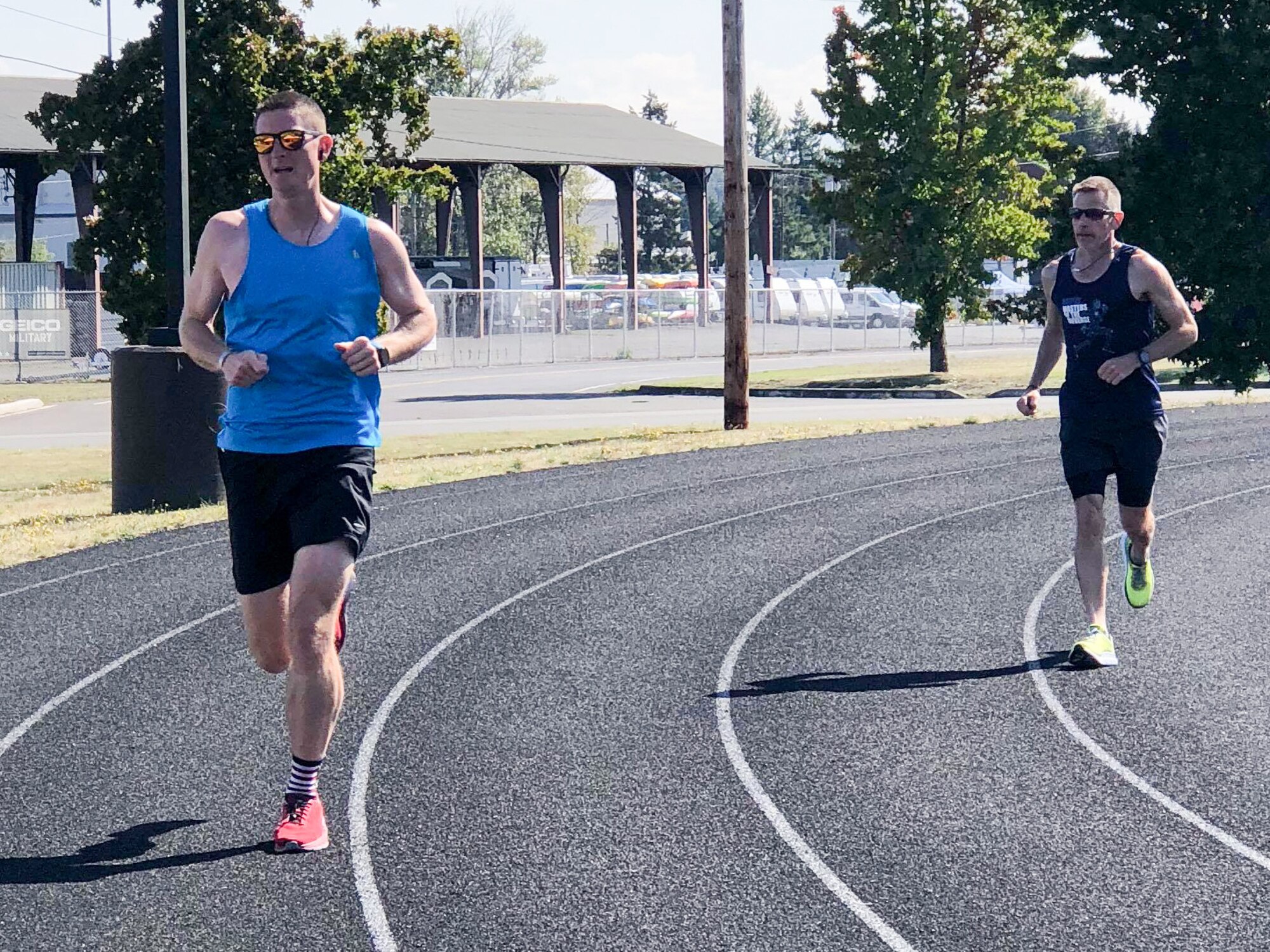 1st Lt. Krosby Keller, left, 225th Air Defense Squadron air battle manager, runs with Bruce Robie, right, 225th Support Squadron National Airspace System Defense program manager, during the Joint Base Lewis-McChord 24-Hour POW/MIA Remembrance Run Sept. 18, 2018.  Keller placed first in individual standings with 100 miles and Robie finished second in the individual standing with 74 miles.