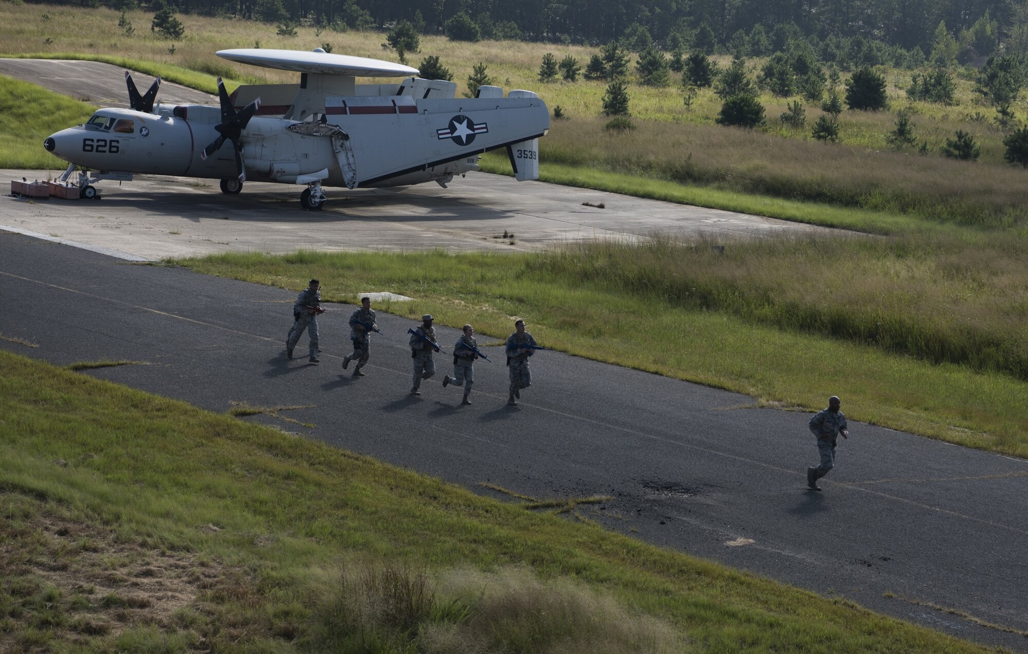 Security forces Airmen with Air Mobility Command run in full gear during while training for the 2018 Air Force Defender Challenge on Joint Base McGuire-Dix-Lakehurst, New Jersey, Sept. 5, 2018. The AMC team was one of 14 teams representing each of the 10 Air Force major commands, the Air National Guard, the Air Force District of Washington and German and British Royal air forces. (U.S. Air Force photo by Airman Ariel Owings)