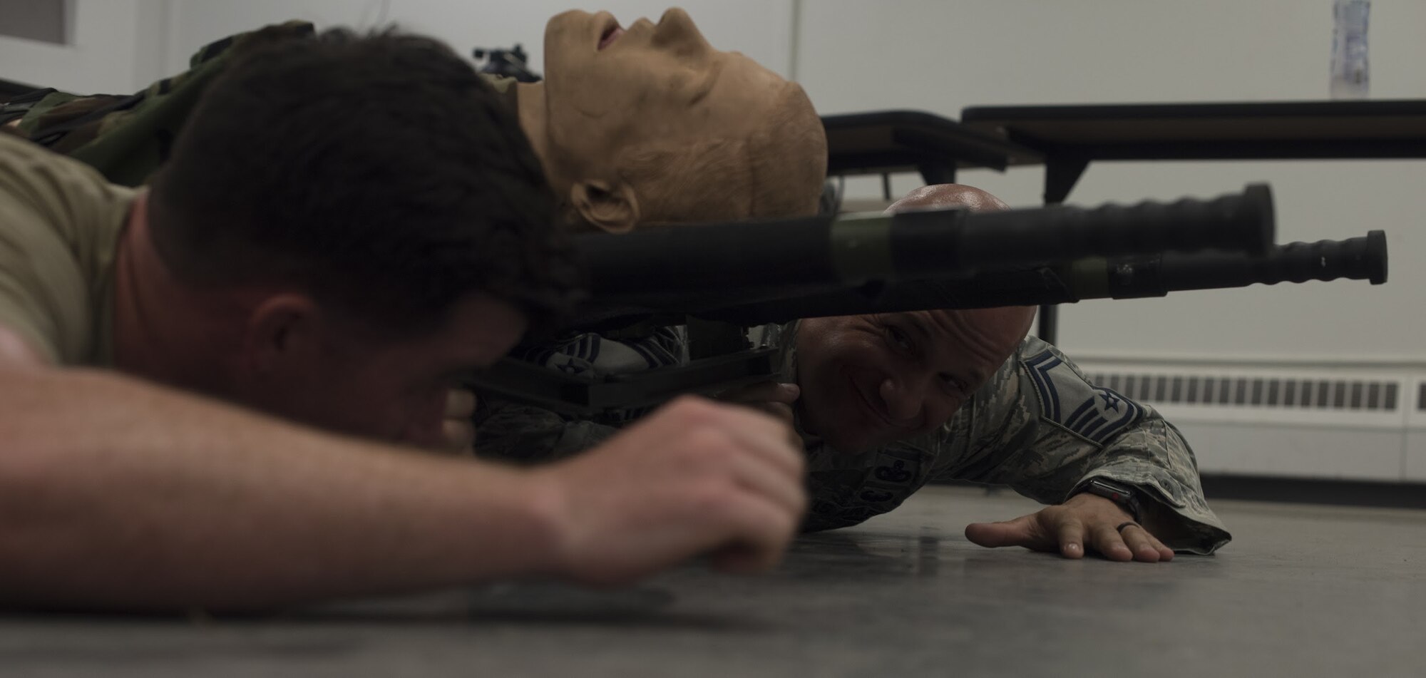 U.S. Air Force Staff Sgt. Luciano Rosano, Joint Base McGuire-Dix-Lakehurst, New Jersey, 421st Security Forces Squadron combat training instructor, and Senior Master Sgt. Thomas Carpino, MacDill Air Force Base, Florida, 6th Security Forces Squadron NCO in charge and Air Mobility Command team coach, practice carrying a litter during training for the 2018 Air Force Defender Challenge on Joint Base MDL, Sept. 5, 2018. Litter carries enables transportation of injured personnel while low crawling under fire.