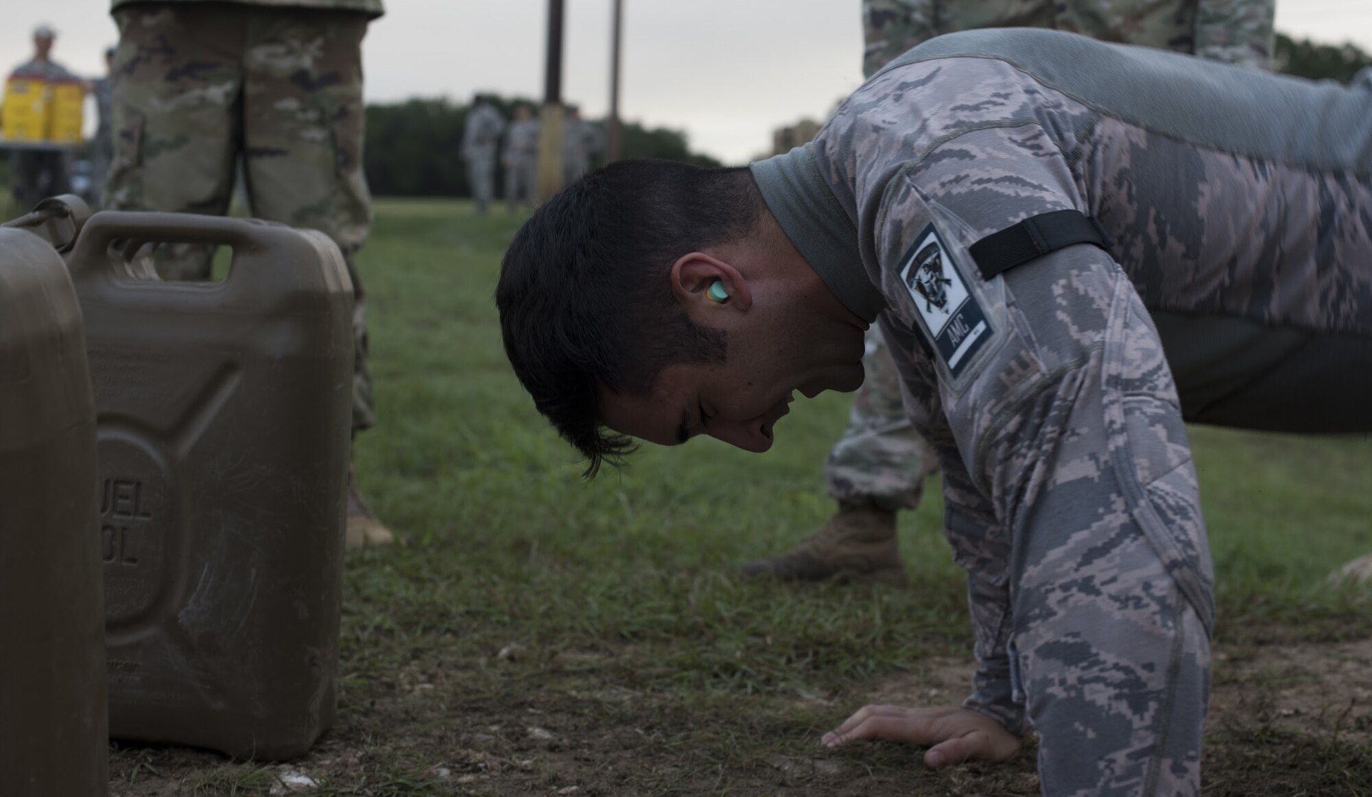 Senior Airman Anthony Hu, 6th Security Forces Squadron military working dog handler and Air Mobility Command team member, performs pushups during the 2018 Air Force Defender Challenge on Joint Base San Antonio-Camp Bullis, Texas, Sept. 13, 2018. Hu performed the last exercise of the combat endurance test on the last day of the three-day competition. (U.S. Air Force photo by Airman Ariel Owings)