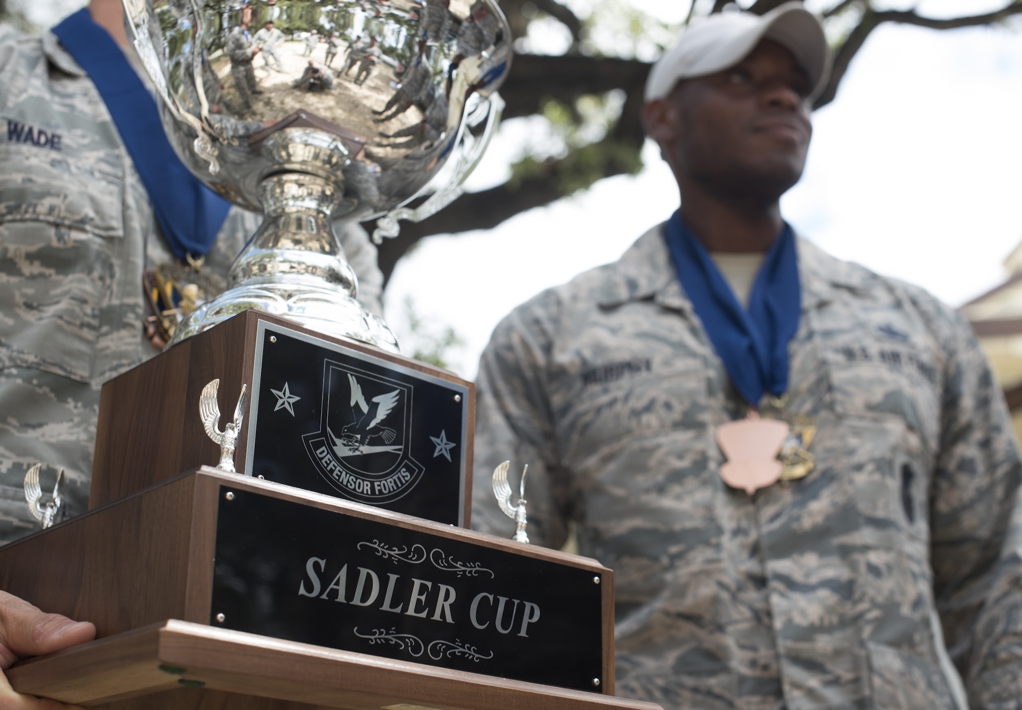 Air Mobility Command security forces Airmen hold the Sadler Cup after the 2018 Air Force Defender Challenge award ceremony on Joint Base San Antonio-Camp Bullis, Texas, Sept. 13, 2018. The Sadler Cup was awarded to the AMC team for placing first in the dismounted operations component of the three-day competition. (U.S. Air Force photo by Airman Ariel Owings)