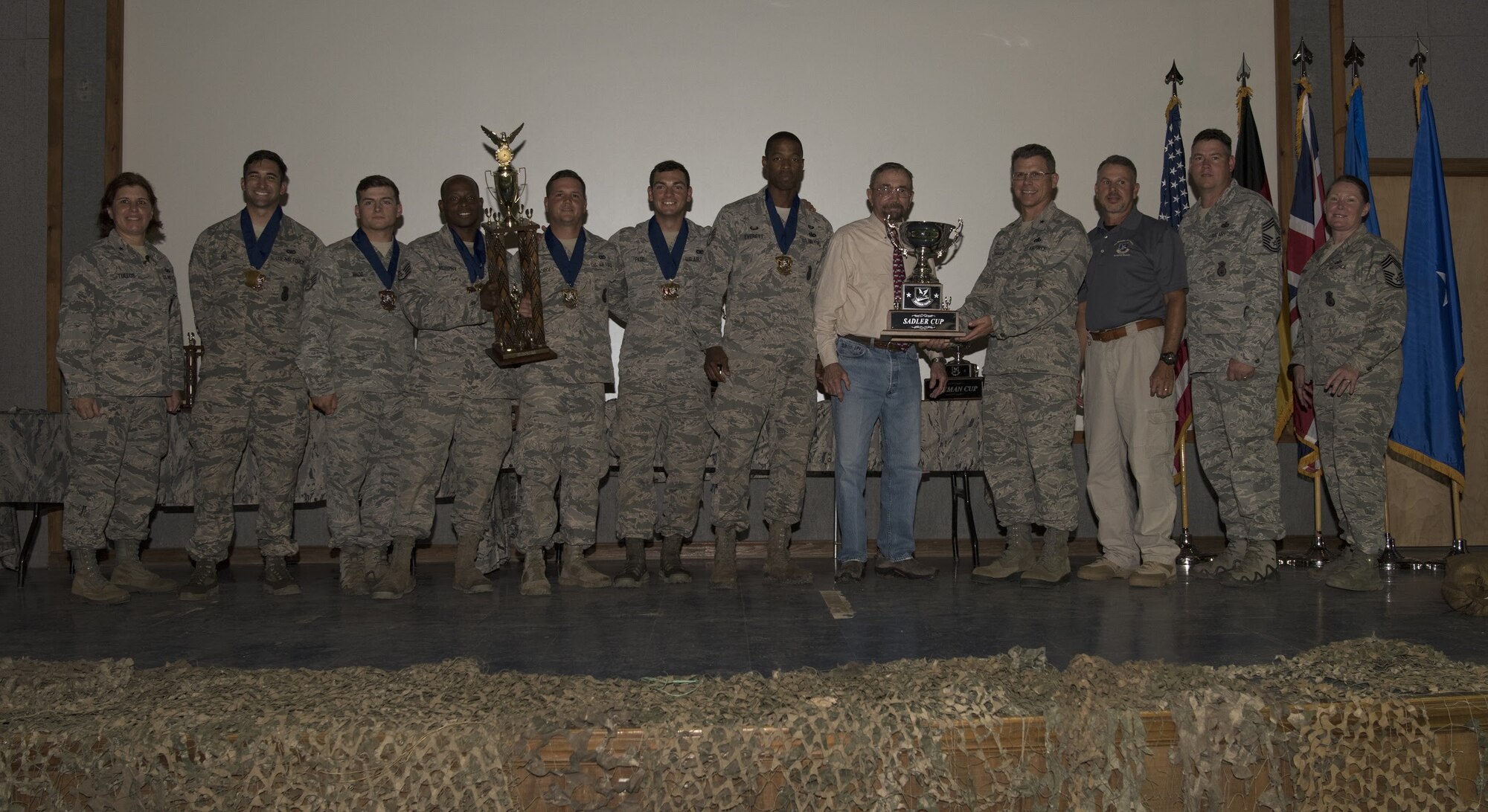 U.S. Air Force Brig. Gen. Andrea Tullos, security forces director, and Brig. Gen. Steven Bleymaier, AMC director of logistics, engineering and force protection, present the Sadler Cup to the AMC team during the 2018 Air Force Defender Challenge awards ceremony on Joint Base San Antonio-Camp Bullis, Texas, Sept. 13, 2018. The Sadler Cup was awarded to AMC for winning the dismounted operations challenge of the three-day competition. (U.S. Air Force photo by Airman Ariel Owings)