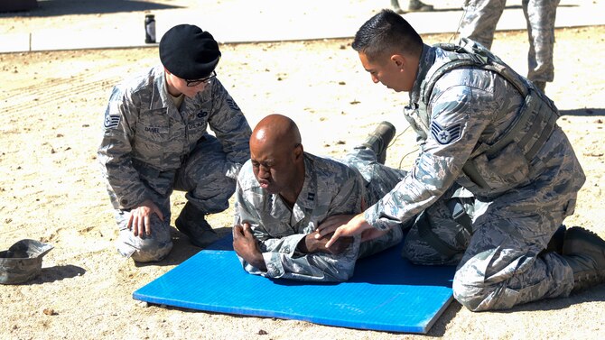 Chaplain (Capt.) Richardson Honore gets tased by 412th Security Forces Squadron personnel as part of a capabilities demonstration at Edwards Air Force Base, California, Sept. 13, 2018. Honore serves as the 412th SFS chaplain and volunteered to be tased in order to get better understanding of different stress factors that Defenders face every day. (U.S. Air Force photo by Giancarlo Casem)