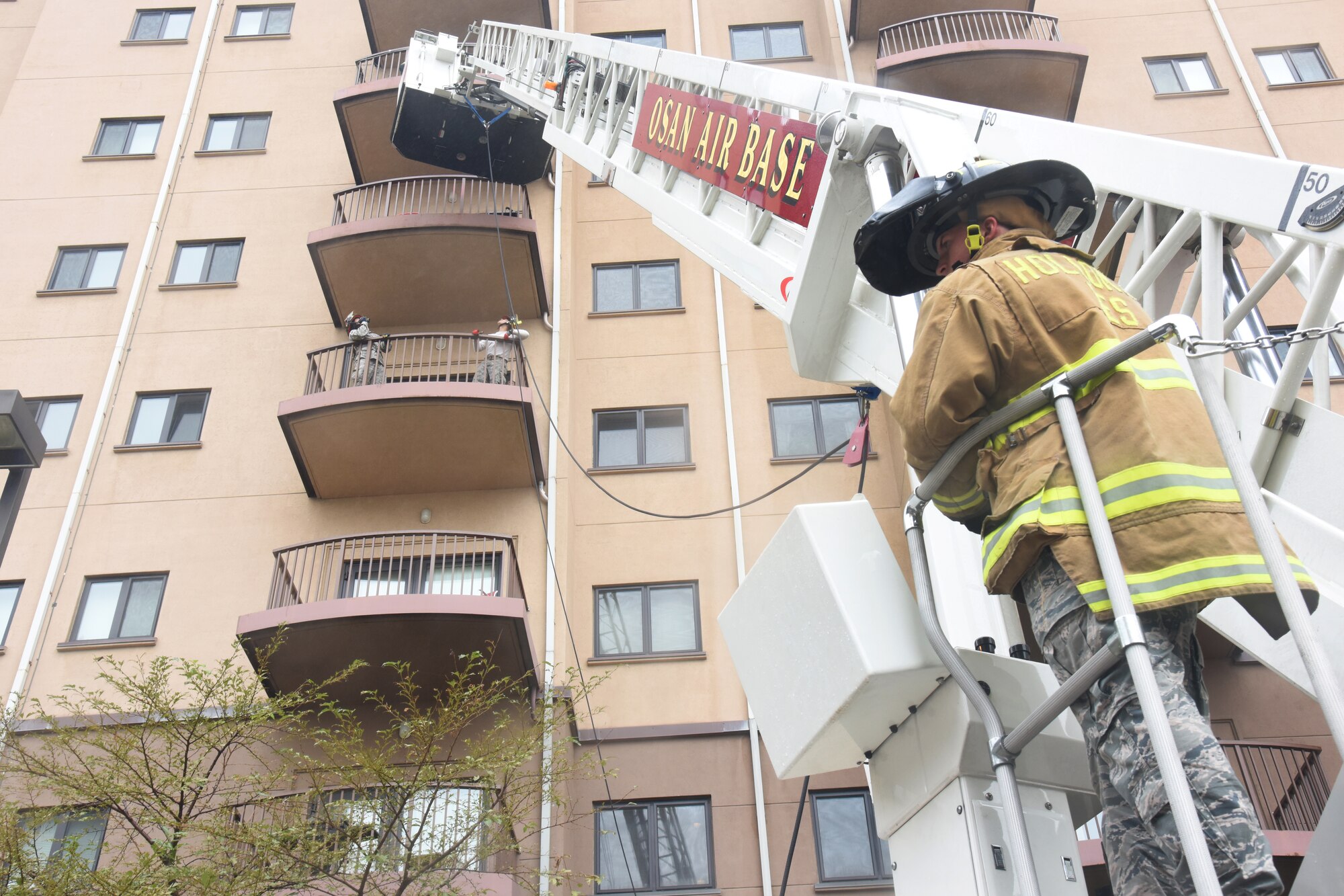 Firefighters with the 51st Civil Engineer Squadron fire department lower a stretcher to evacuate a victim from a simulated burning building during a mass casualty exercise at Osan Air Base, Republic of Korea, Sept. 20, 2018. The firefighters used the exercise to evaluate their knowledge in the proper use of rope and rescue equipment. (U.S. Air Force photo by Tech. Sgt. Ashley Tyler)