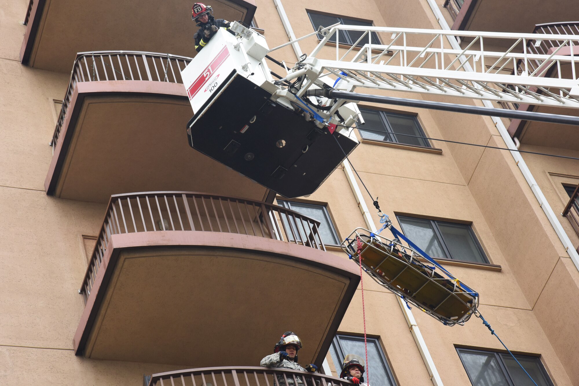Firefighters with the 51st Civil Engineer Squadron fire department lower a stretcher to evacuate a victim from a simulated burning building during a mass casualty exercise at Osan Air Base, Republic of Korea, Sept. 20, 2018. The firefighters used the exercise to evaluate their knowledge in the proper use of rope and rescue equipment. (U.S. Air Force photo by Tech. Sgt. Ashley Tyler)