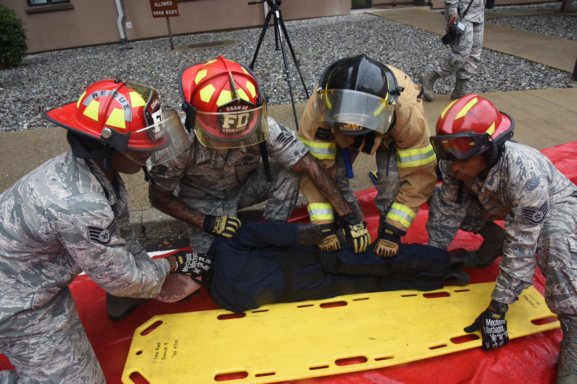 Firefighters with the 51st Civil Engineer Squadron fire department prepare a simulated victim to be treated by medical personnel during a mass casualty exercise at Osan Air Base, Republic of Korea, Sept. 20, 2018. The fire department worked closely with the 51st Medical Group to evaluate their response time and training on evacuating casualties from a high angle, transporting them to medical care and receiving treatment. (U.S. Air Force photo by Tech. Sgt. Ashley Tyler)