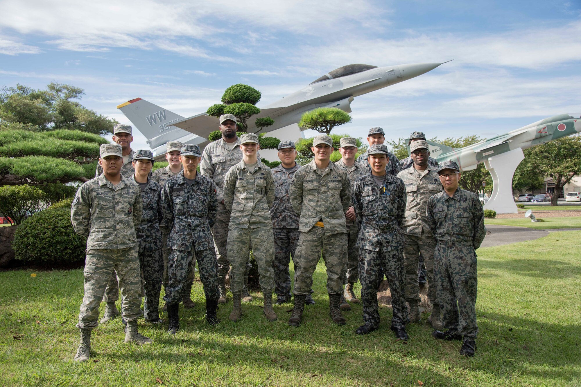 Japan Air Self-Defense Force and U.S. Air Force personnel stand united for a group photo during a Bilateral Exchange Program visit at Misawa Air Base, Japan, Sept. 18, 2018. The group split into pairs to learn the differences and similarities of each other’s careers over the course of 10 days. (U.S. Air Force photo by Senior Airman Sadie Colbert)