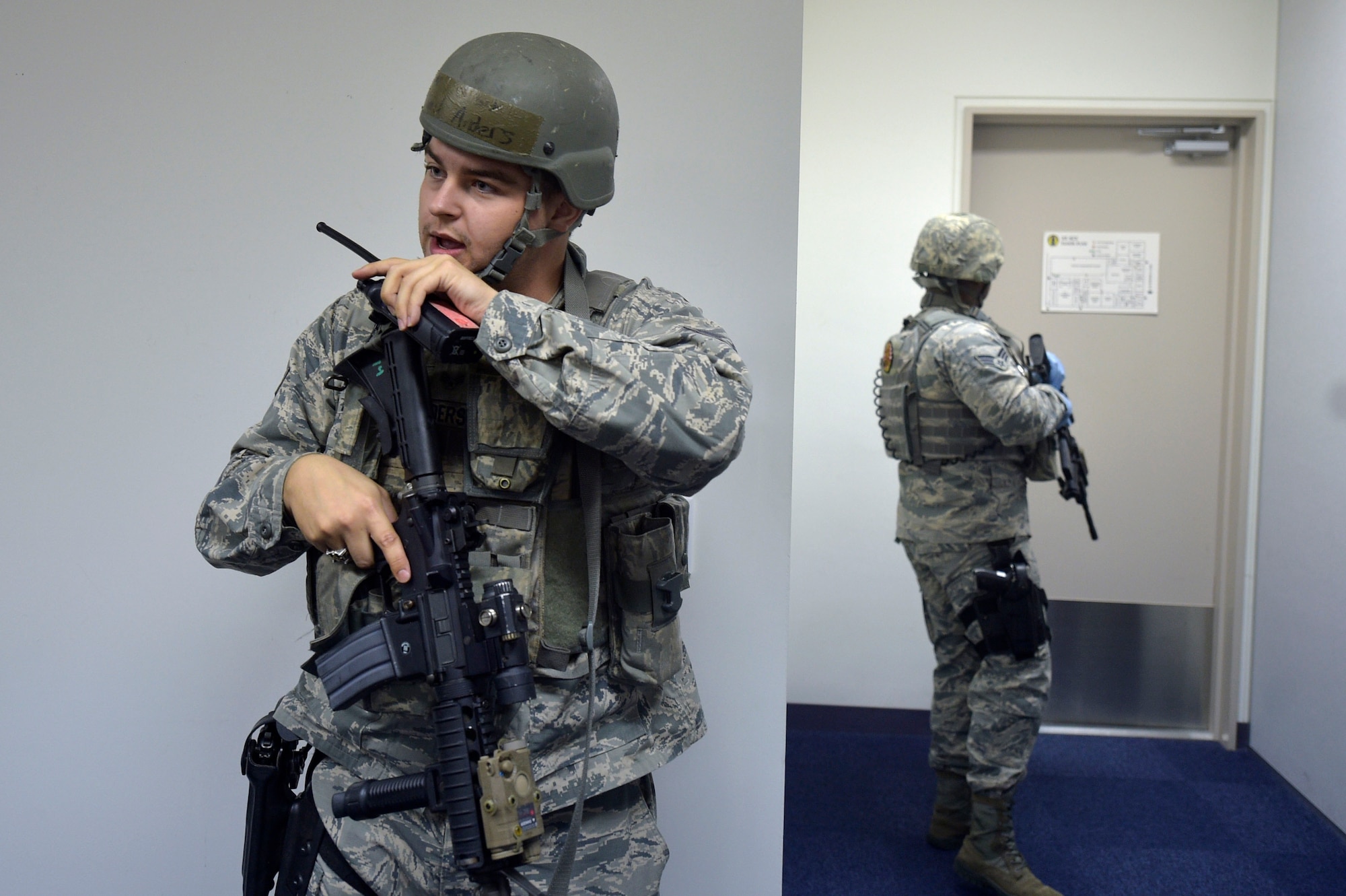 U.S. Air Force Senior Airman Daniel Anders, left, a 35th Security Forces Squadron defender, talks on a radio during an active shooter exercise at Misawa Air Base, Sept. 18, 2018. The exercise helped security forces personnel identify any short falls or limiting factors in their response capabilities. This aids in providing an effective and timely response to minimize the loss of life in the event of an active shooter. (U.S. Air Force photo by Tech. Sgt. Stephany Johnson)