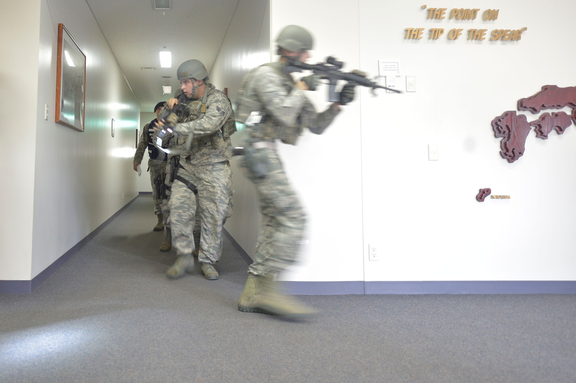 U.S. Air Force Senior Airman Daniel Anders, left, and Airman 1st Class Michael Curran, right, both 35th Security Forces Squadron defenders, perform a search of the Tori building during an active shooter exercise at Misawa Air Base, Sept. 18, 2018. Active shooter exercises are held to test base safety and security in case of a real-world scenario. (U.S. Air Force photo by Tech. Sgt. Stephany Johnson)