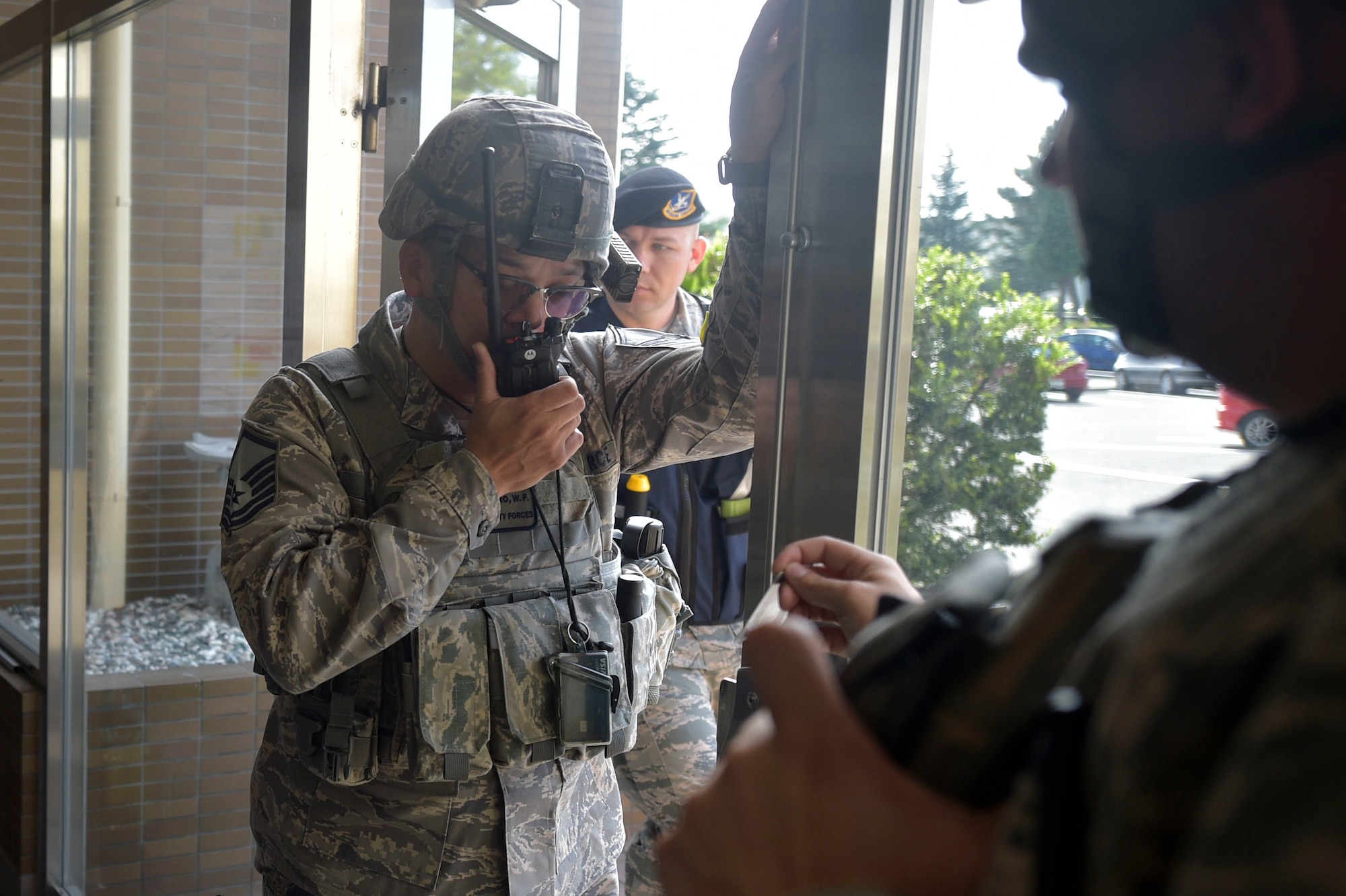 U.S. Air Force Master Sgt. William Castro, the 35th Security Forces Squadron bravo flight chief, talks on a radio during an active shooter exercise at Misawa Air Base, Sept. 18, 2018. The training exercise focused on how quickly and effectively first responders locate the source of the threat, while treating victims. (U.S. Air Force photo by Tech. Sgt. Stephany Johnson)