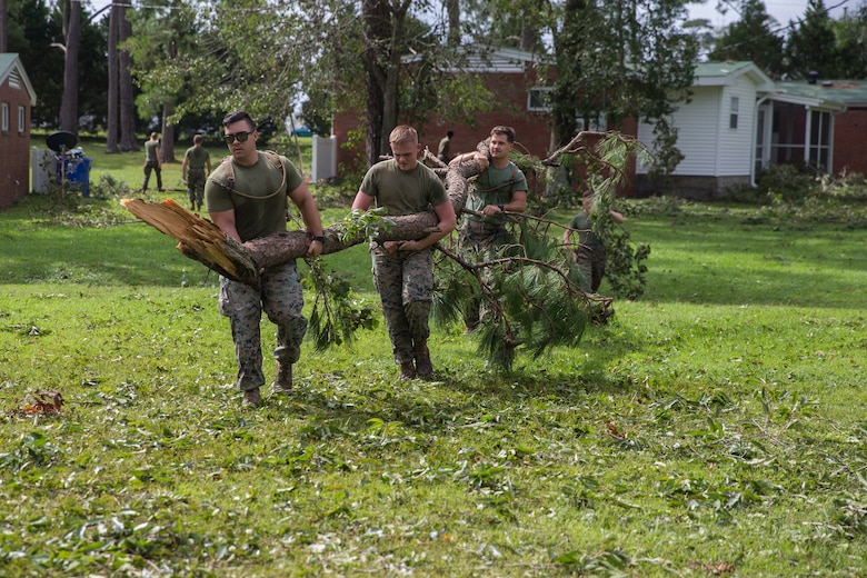 U.S. Marines with Marine Corps Air Station New River conduct a clean up effort after Hurricane Florence at McCutcheon Manor on MCAS New River, N.C., Sept. 17, 2018. Hurricane Florence impacted Marine Corps Base Camp Lejeune and MCAS New River with periods of strong winds, heavy rains, flooding of urban and low lying areas, flash floods and coastal storm surges.  (U.S. Marine Corps photo by Lance Cpl. Damaris Arias)