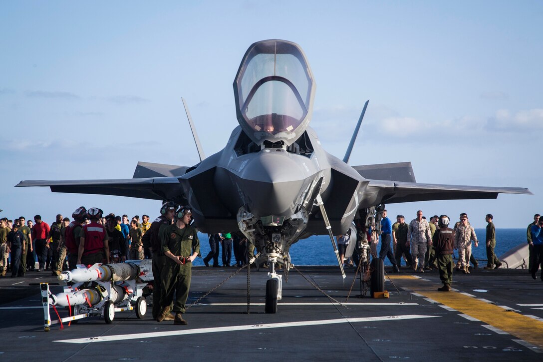 U.S. Marines and Sailors with the 13th Marine Expeditionary Unit and the Essex Amphibious Ready Group, look for debris on the flight deck before flight operations aboard the Wasp-class amphibious assault ship USS Essex, Sept. 22, 2018. The Essex is the flagship for the Essex Amphibious Ready Group and, with the embarked 13th MEU, is deployed to the U.S. 5th Fleet area of operations in support of naval operations to ensure maritime stability and security in the Central Region, connecting the Mediterranean and the Pacific through the western Indian Ocean and three strategic choke points.