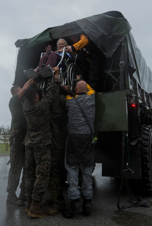 U.S. Marines assigned to Combat Logistics Group 8 and first responders of Richlands Volunteer Fire Dept. 14 offload civilians affected by Hurricane Florence at a local shelter in Jacksonville, N.C., Sept. 15, 2018. CLB-8 is responsible for providing logistical support in the evacuating efforts for the local populace. Hurricane Florence, with its heavy rain and strong winds, is the biggest storm to hit the Carolinas since Hurricane Floyd in 1999, causing power outages and flooding damages and forcing many first responders to be ready at a moment’s notice. (U.S. Marine Corps photo by Pfc. Nello Miele)