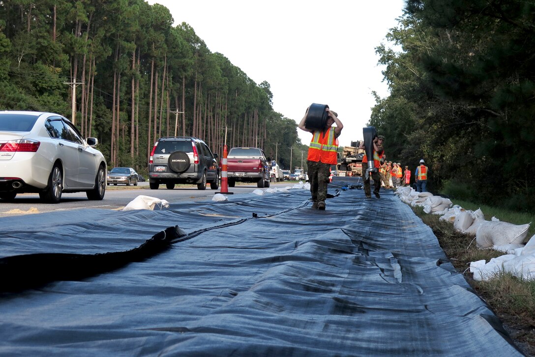 Soldiers carry equipment along a highway in South Carolina.
