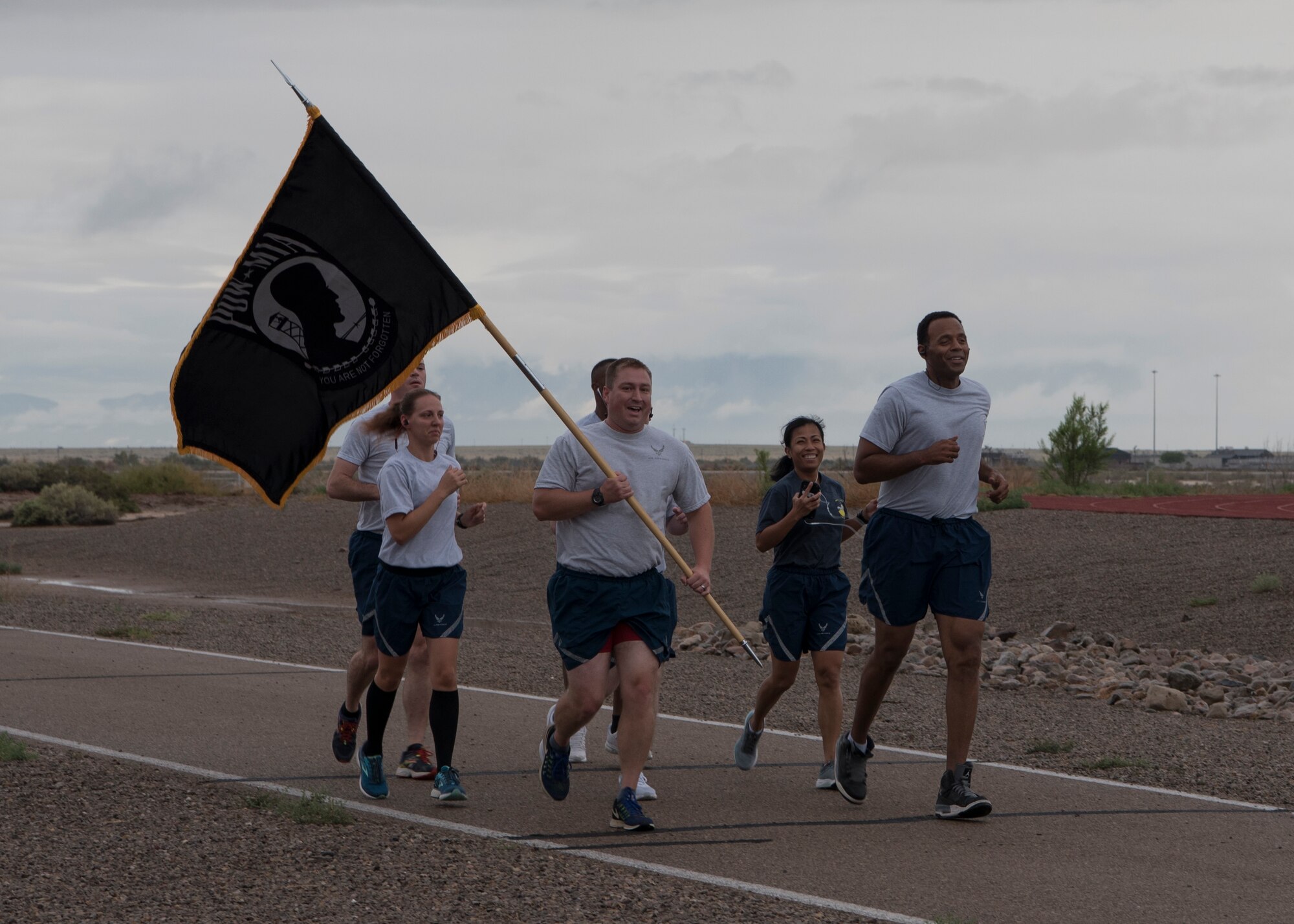 Major Steve Tatro, 49th Wing Comptroller Squadron commander, begins the Prisoner of War/Missing in Action run Sept. 20, at the base track. The Wing Staff Agency was one of the 48 groups to run for half an hour holding the POW/MIA flag. (U.S. Air Force photo by Airman Autumn Vogt)