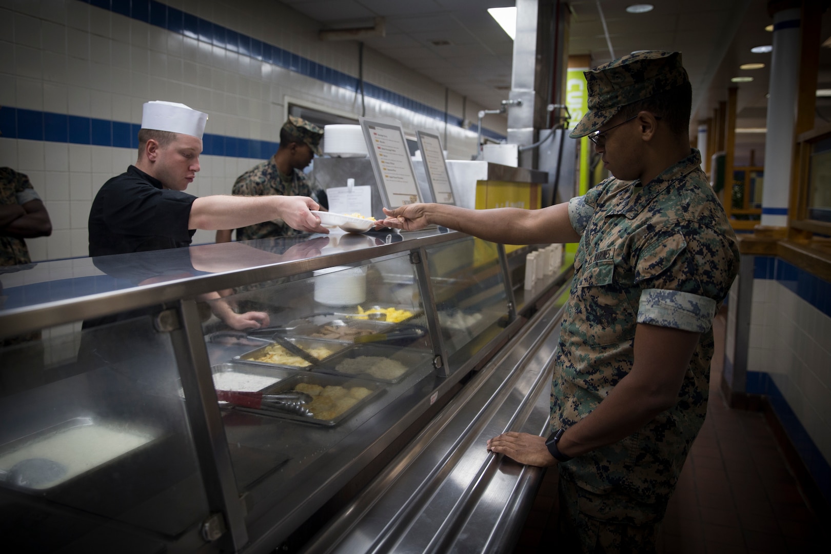 U.S. Marine Corps Cpl. Christopher Modro with 10th Marine Regiment, 2nd Marine Division, serves breakfast to Lance Cpl. Giovani DeleonAcosta, a food service specialist with Headquarters Battalion, 2nd Marine Division, at Camp Lejeune, N.C., Sept. 18, 2018